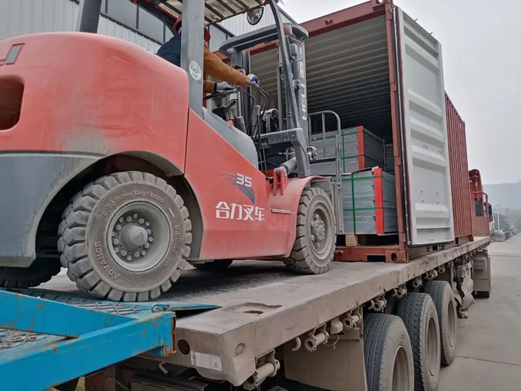 Forklift loading professionally packed billiard slate into an export shipping container.