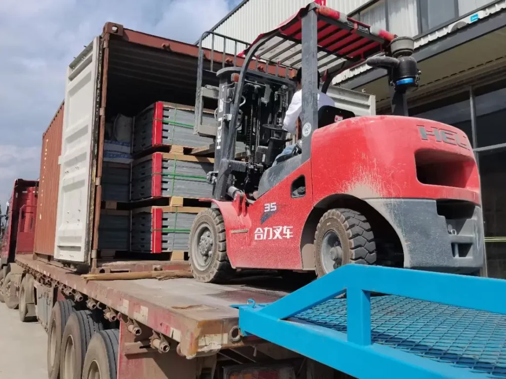 Forklift safely unloading export-packed billiard slates from a shipping container.