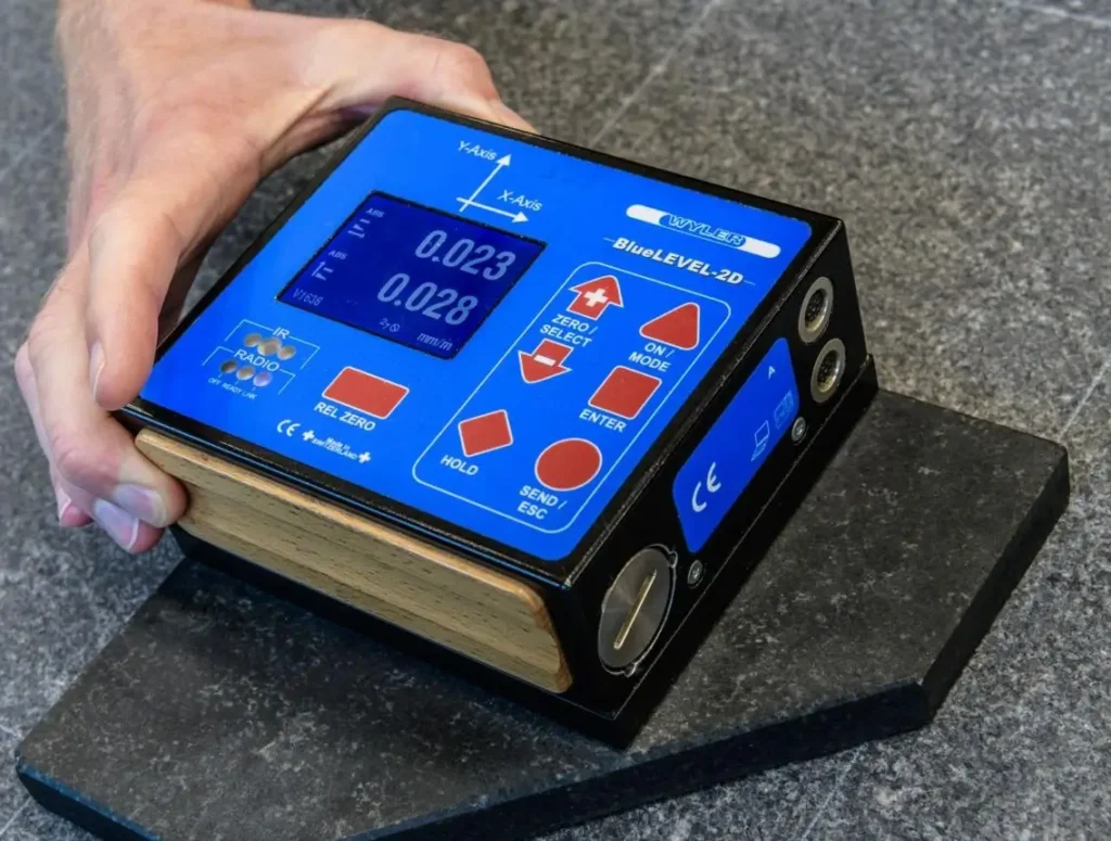 Precision electronic level checking billiard slate during installation