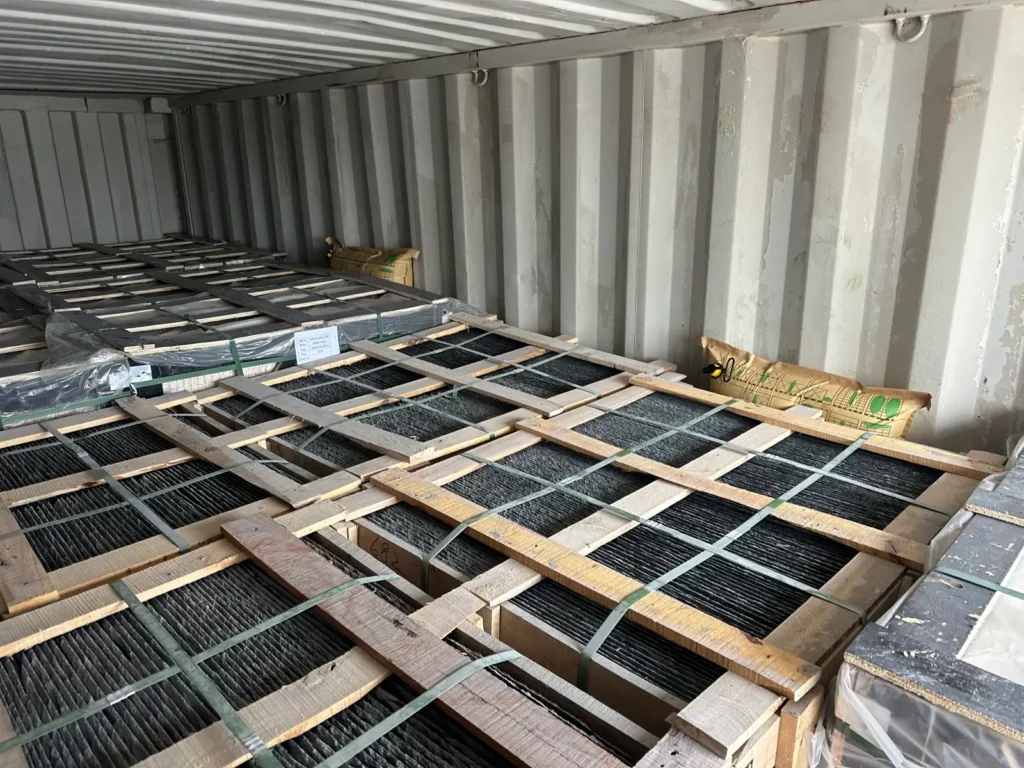 Natural roofing slate tiles packed in wooden crates and loaded inside a shipping container