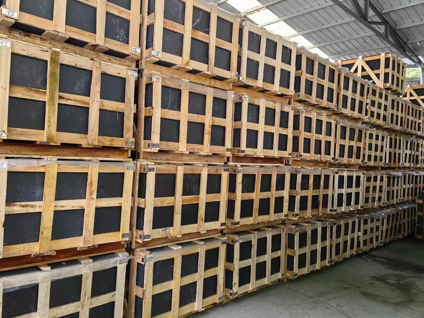Natural roofing slate tiles packed in wooden export crates at a warehouse in Jiujiang, China