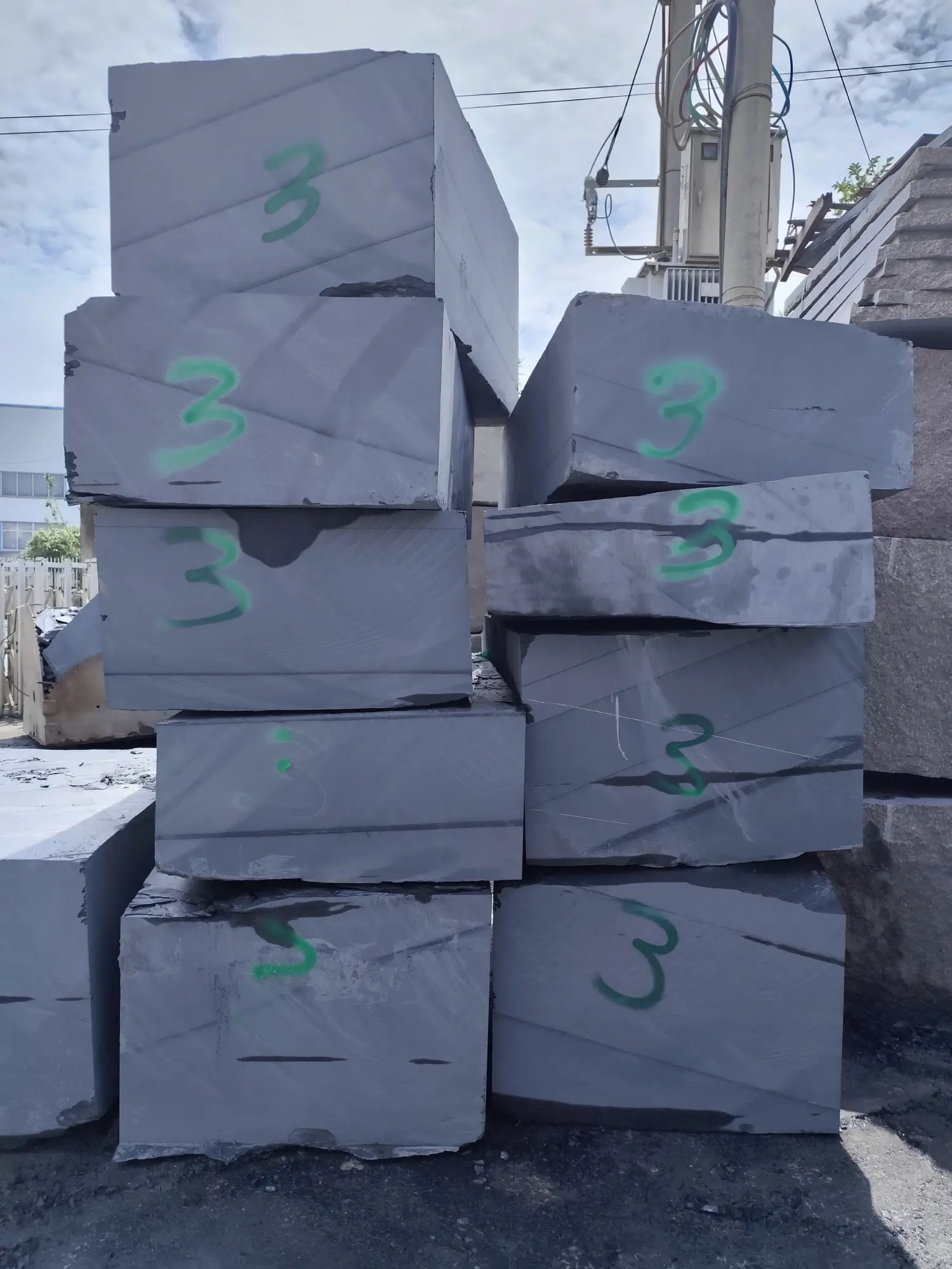 Billiard-grade slate block in the factory selection yard Large slate block selected for billiard panel production sitting in a factory yard