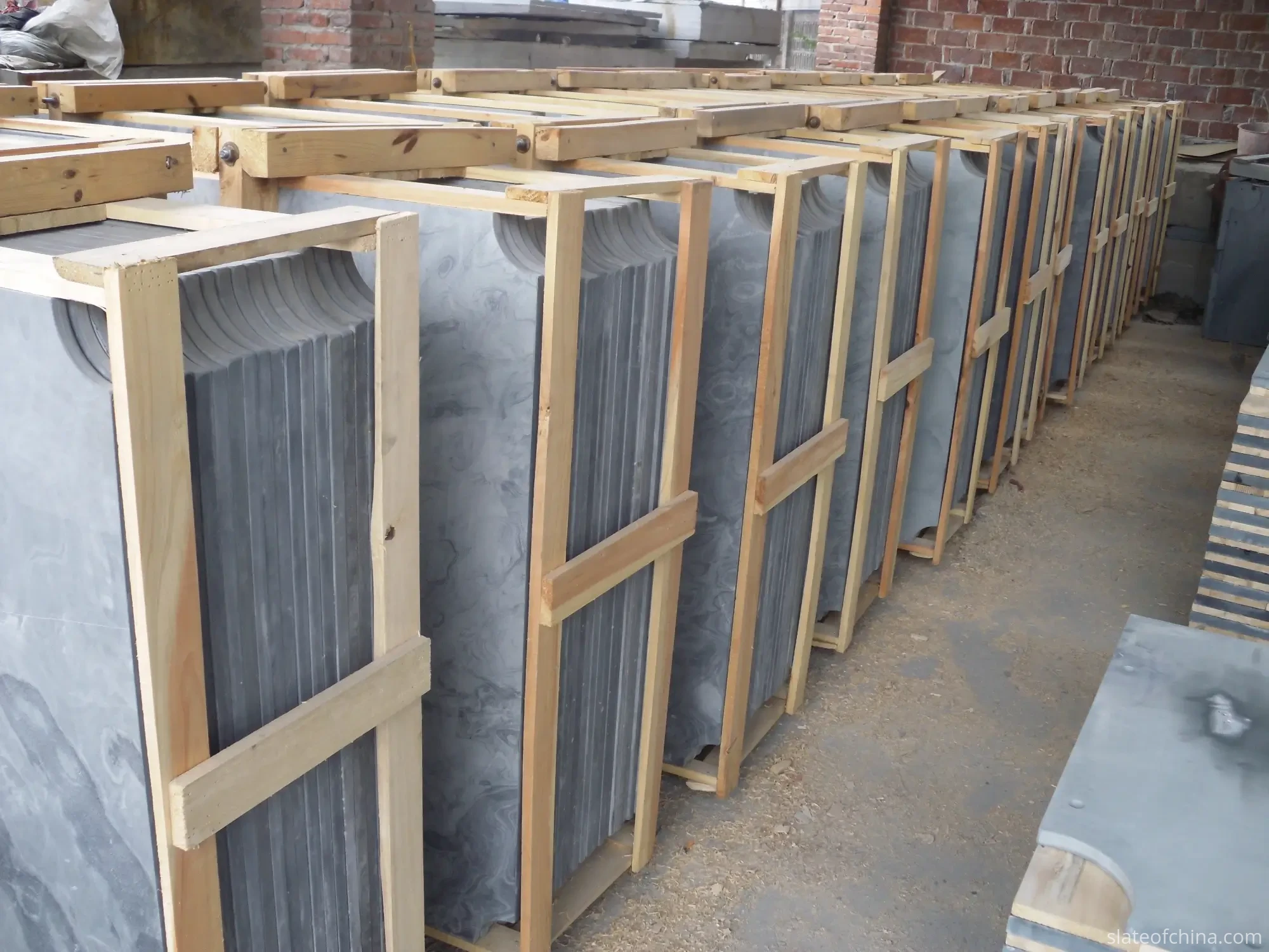 How to Choose a Billiard Slate Manufacturer 1 Billiard slate factory with finished dark grey slate panels crated and stored upright in rows