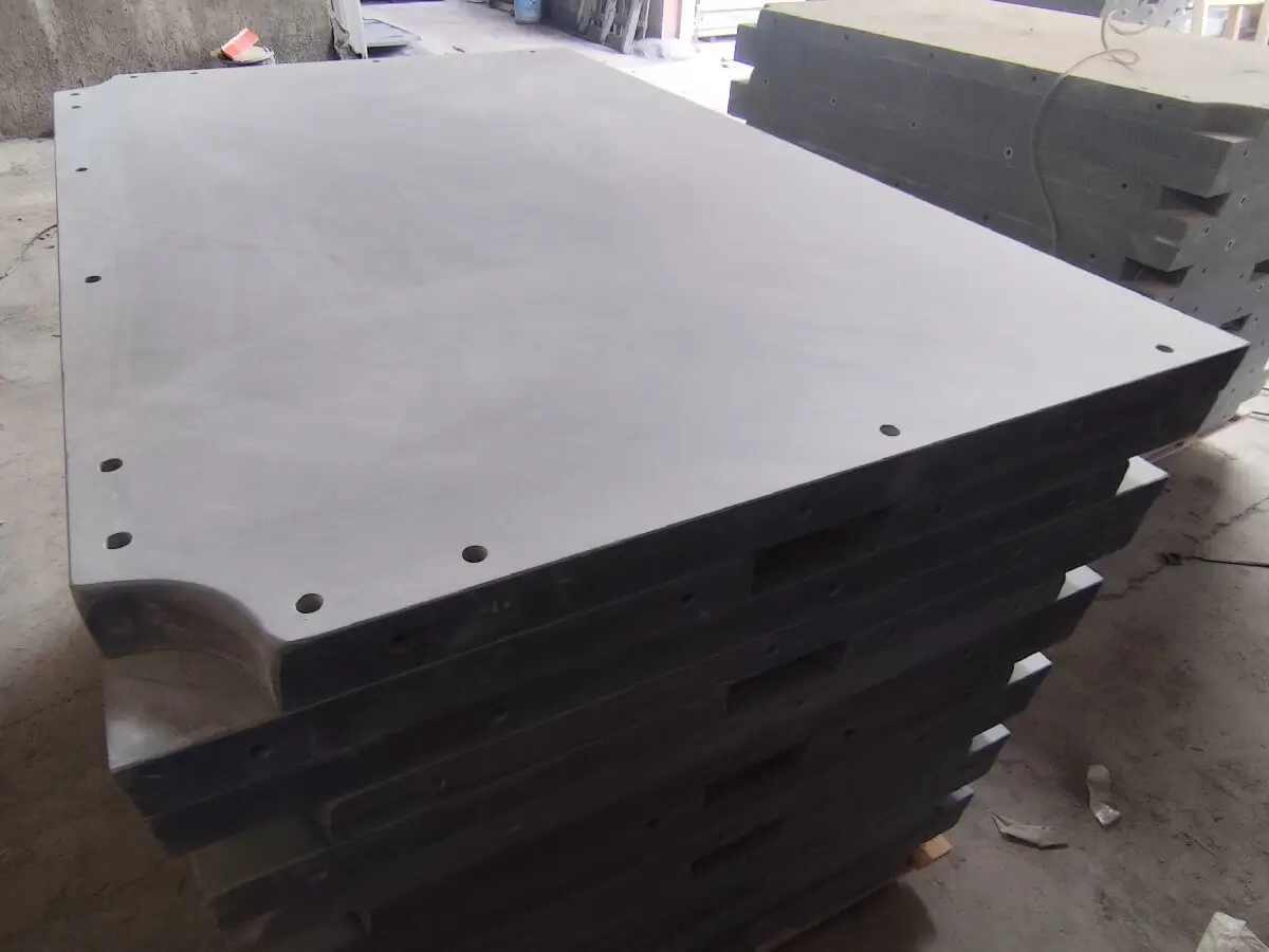 Finished slate panel for a Chinese 8-ball bed A single large finished rectangular slate panel photographed from above on a workshop floor