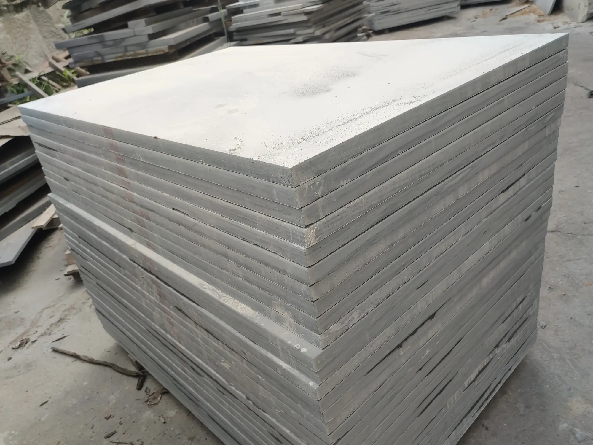 Sawn slate slabs staged in the factory yard Large sawn slate slabs with rough edges leaning upright in rows in a slate factory yard