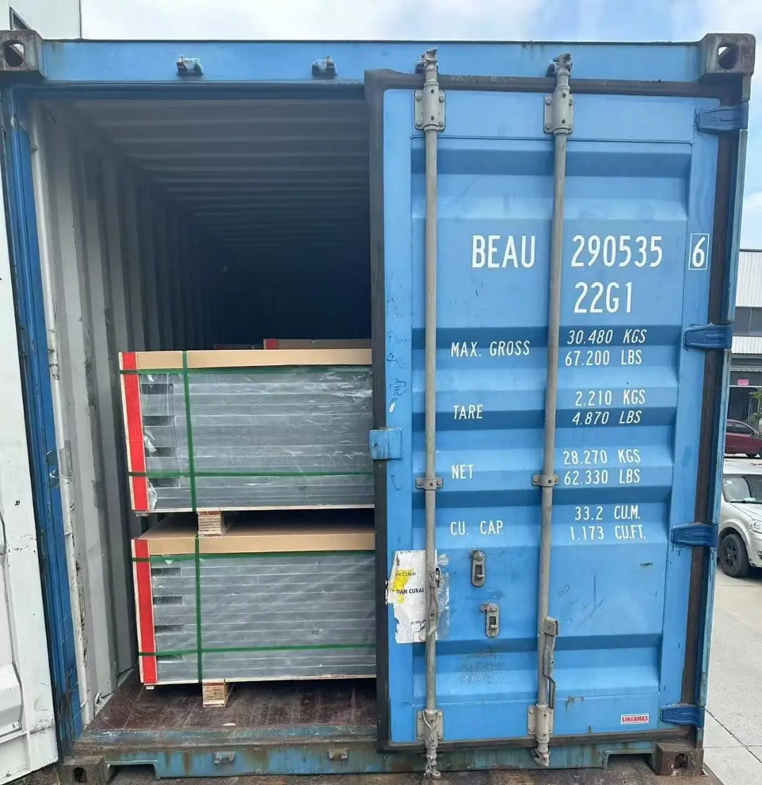 Container doors closing on a slate shipment at the factory Worker closing the doors of a shipping container loaded with slate crates at a factory yard
