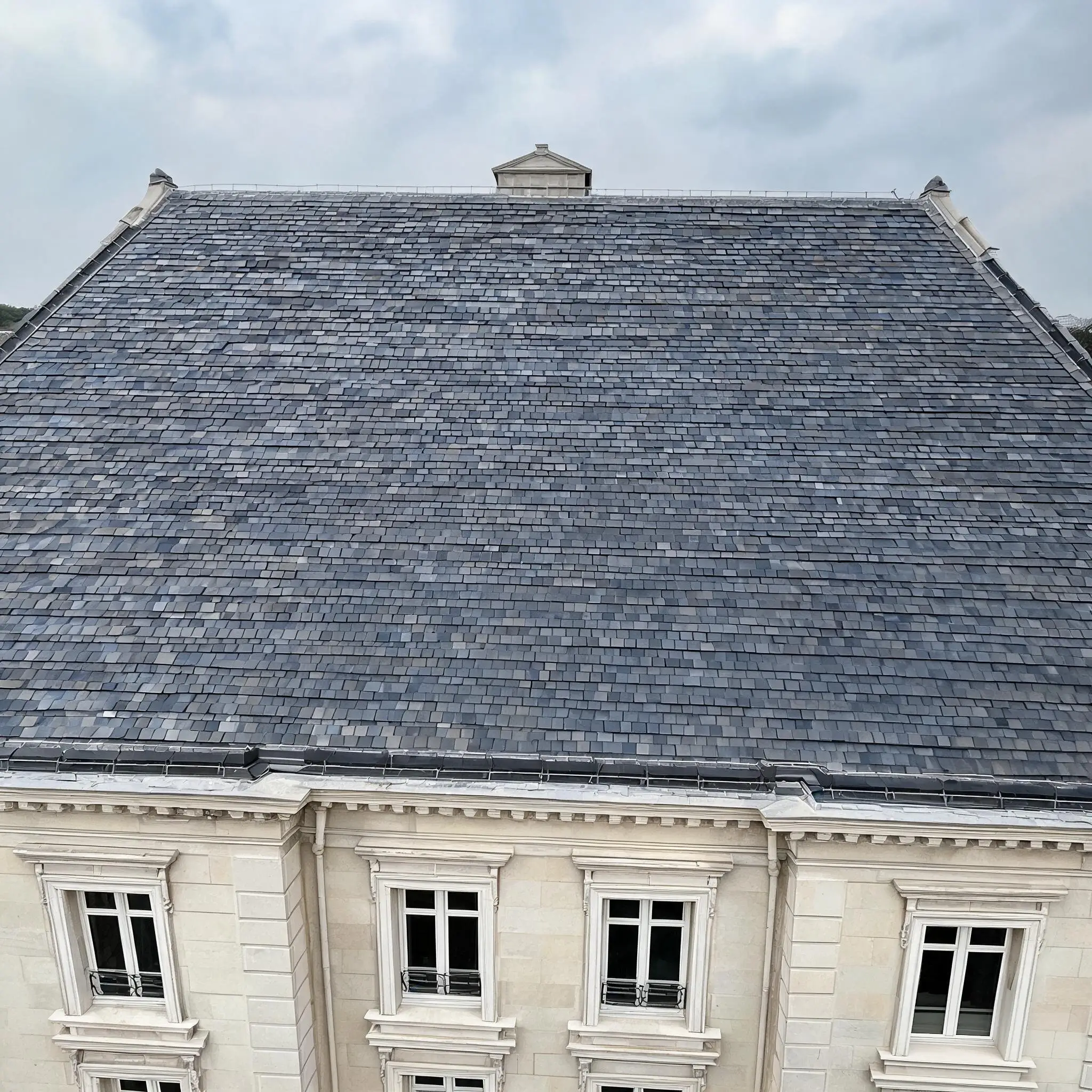 Why Roofing Buyers Choose Jiujiang Slate 6 Completed natural slate roof on a European-style building showing consistent colour and installation