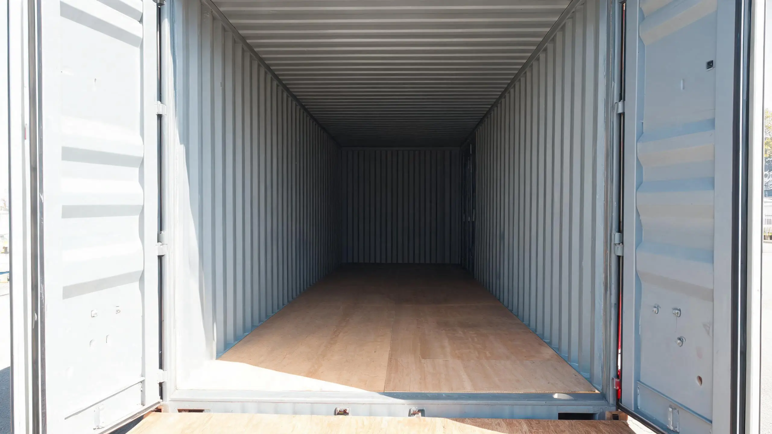 Empty container inspection before slate loading Open doors of an empty shipping container showing the clean dry interior being checked before loading slate