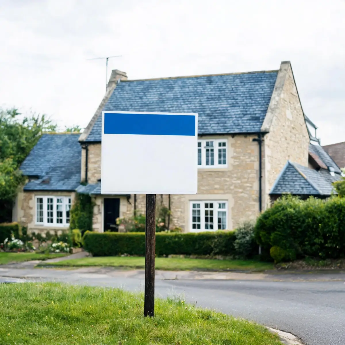 Does Slate Roofing Improve Property Value? 5 An estate agent's For Sale board in front of a slate-roofed property