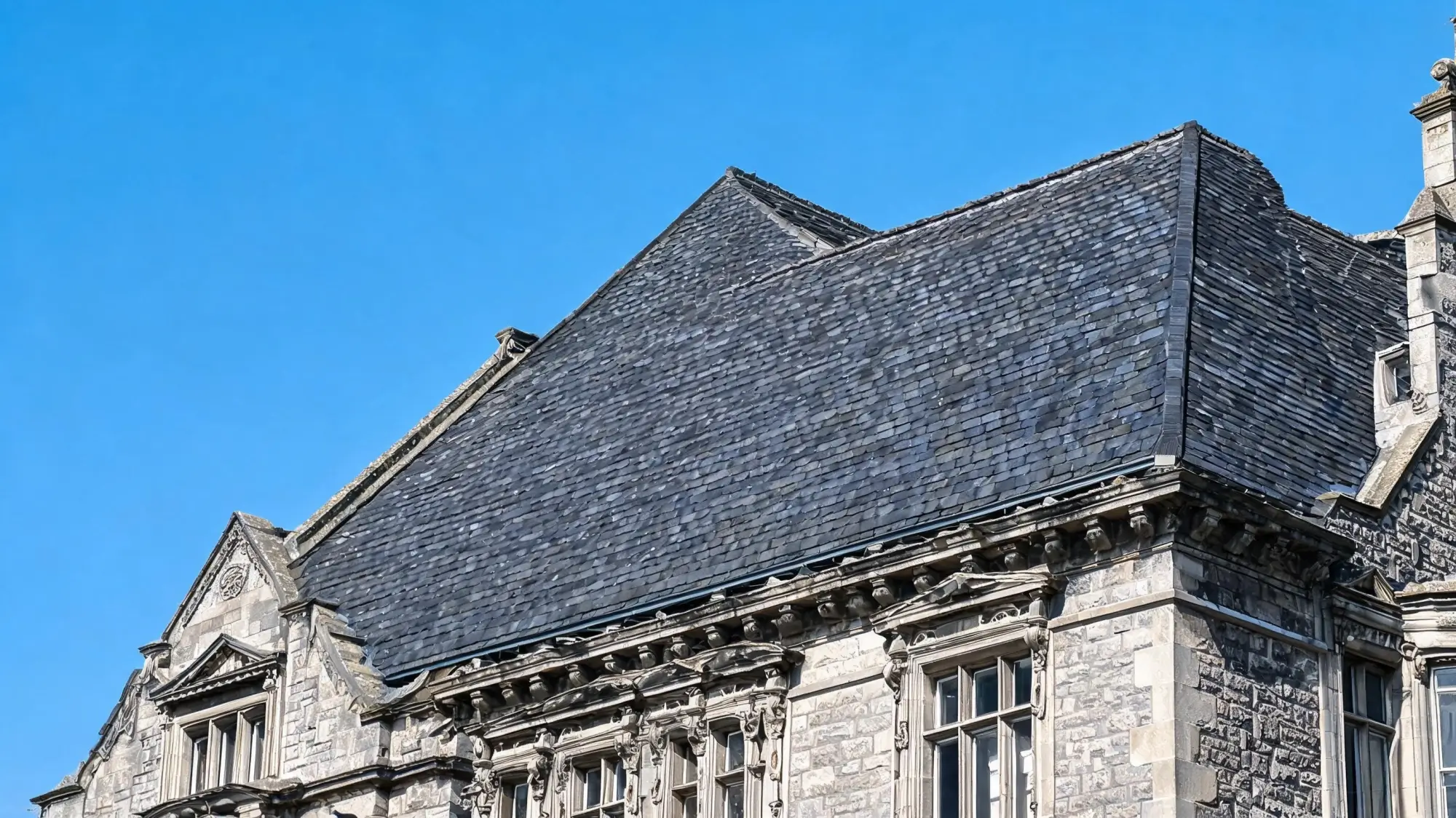 Myths About Natural Roofing Slate 5 Century-old building with original slate roof showing unfaded colour