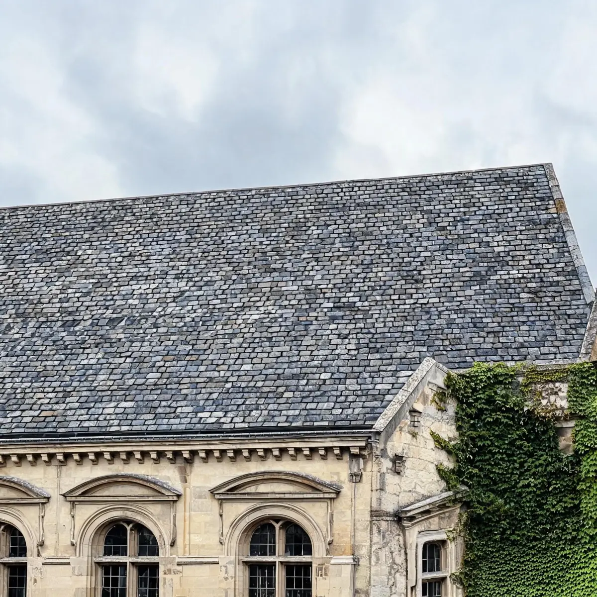 Historic building with weathered natural slate roof still intact after decades