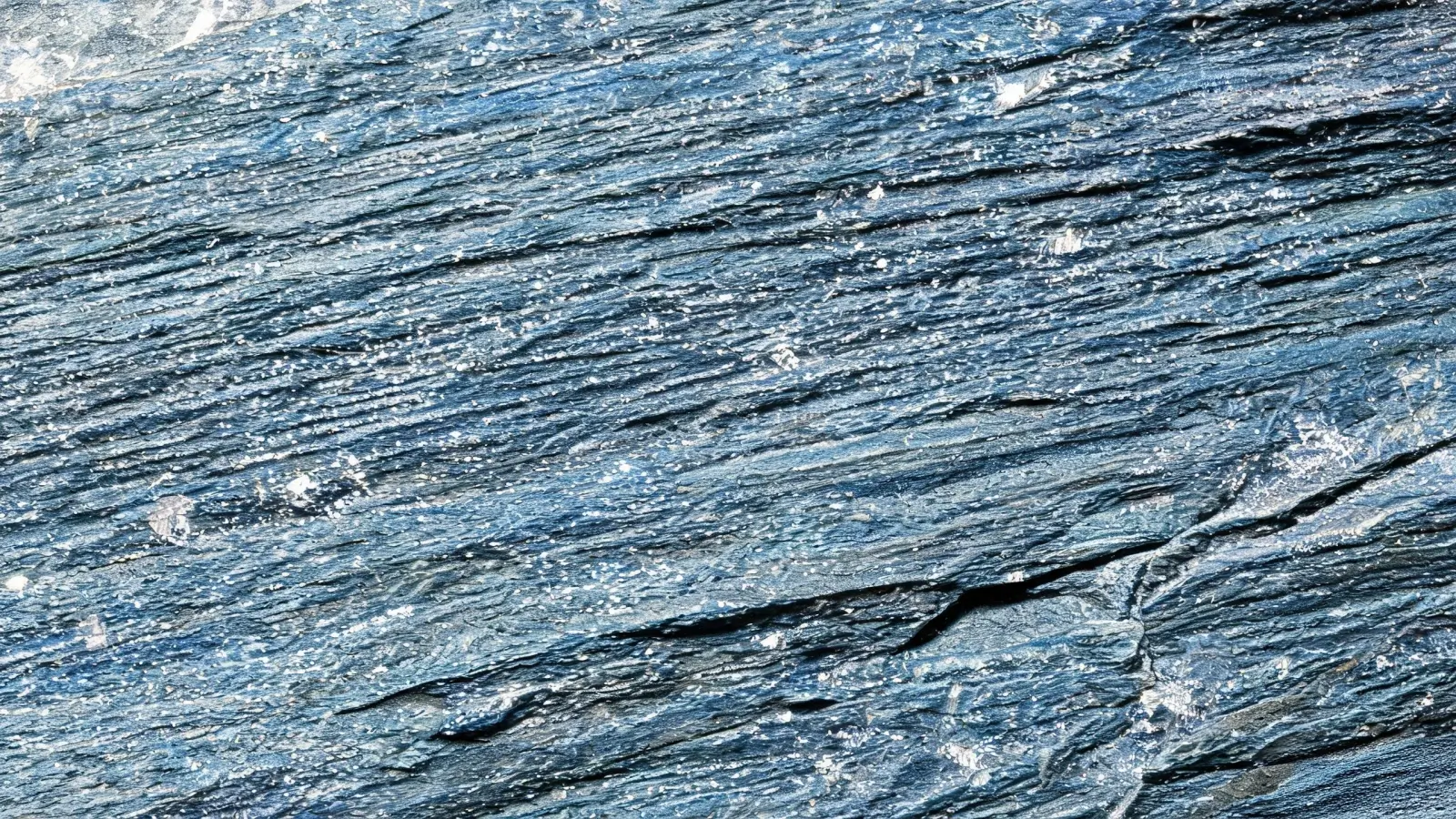 Jiujiang Slate Density 2 Extreme macro of the interlocked mica and quartz grain structure on a freshly split Jiujiang slate face