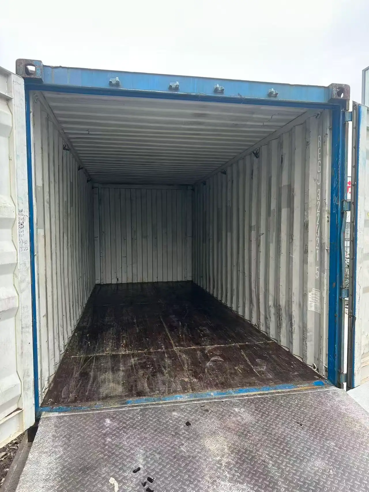 Empty container arrives at the Jiujiang slate factory Empty shipping container standing in a slate factory yard in Jiujiang beside a loading bay door in morning light