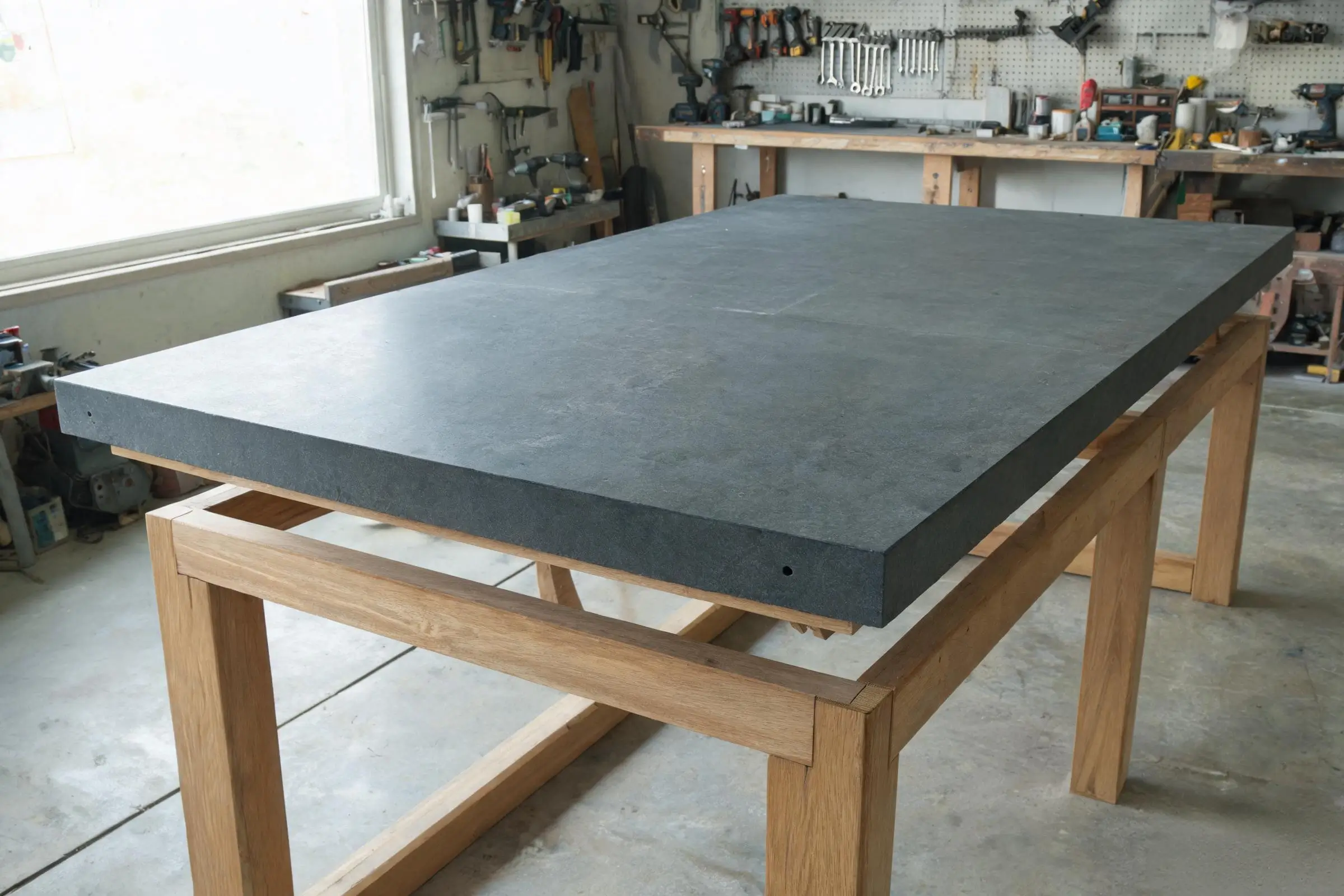 Jiujiang Slate Flexural Strength 5 A precision-ground slate billiard bed panel resting on a wooden table frame showing the 2.4 metre span that the slate must bridge without sagging