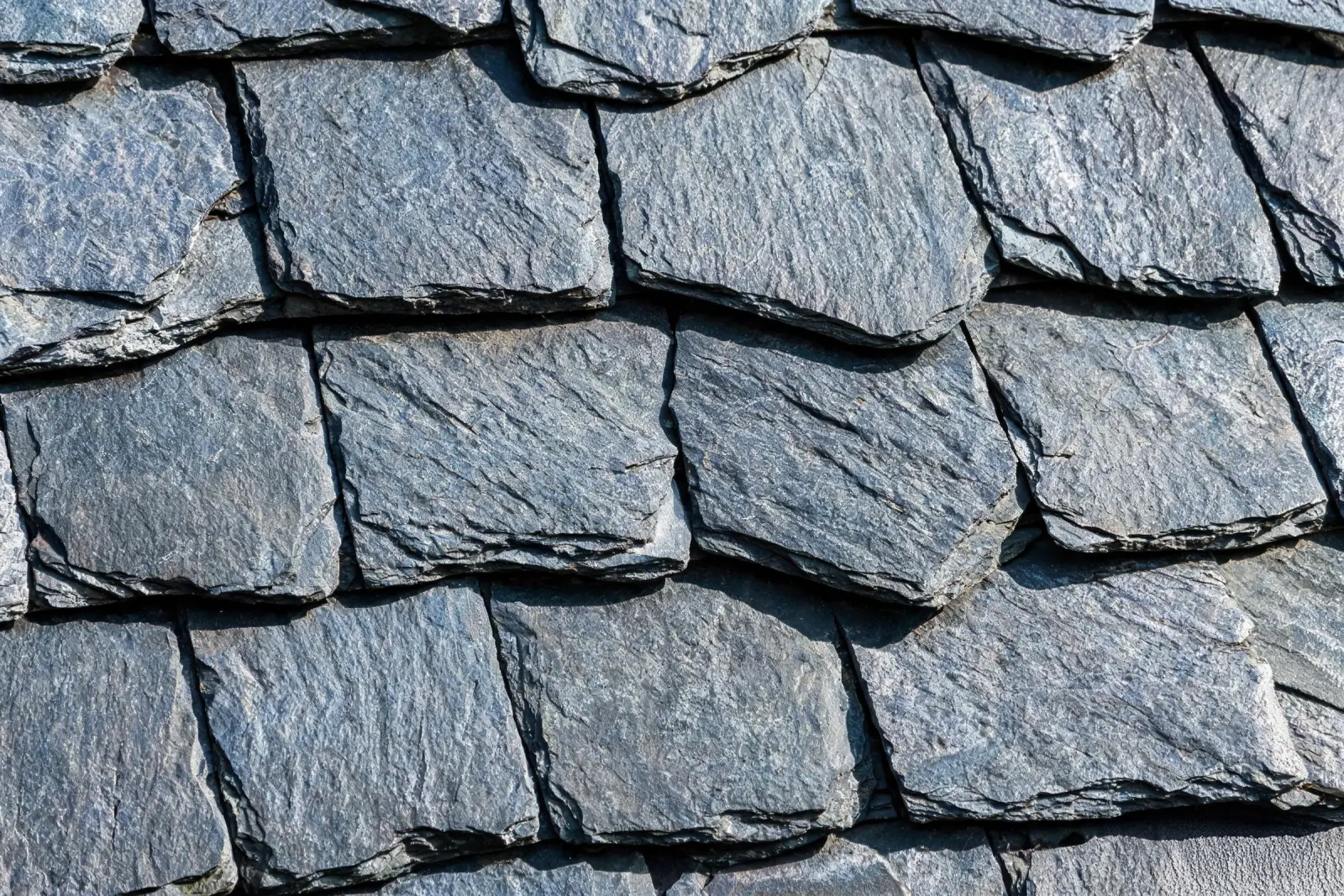 Jiujiang Slate Hardness 5 Close-up of a decades-old natural slate roof surface showing minimal surface wear and the original cleft texture still intact