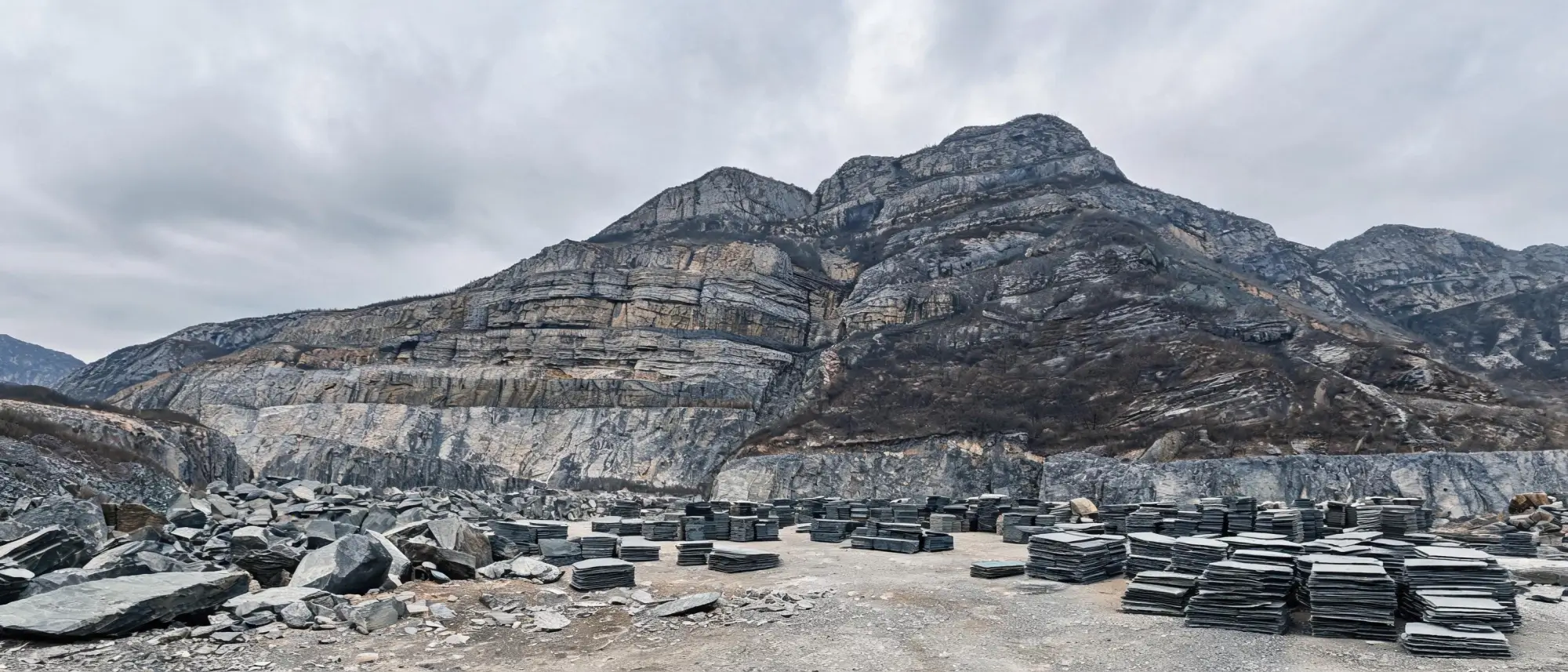 The Jiujiang Slate Industry 1 Panoramic view of a slate quarry mountain and processing yard in the Jiujiang region