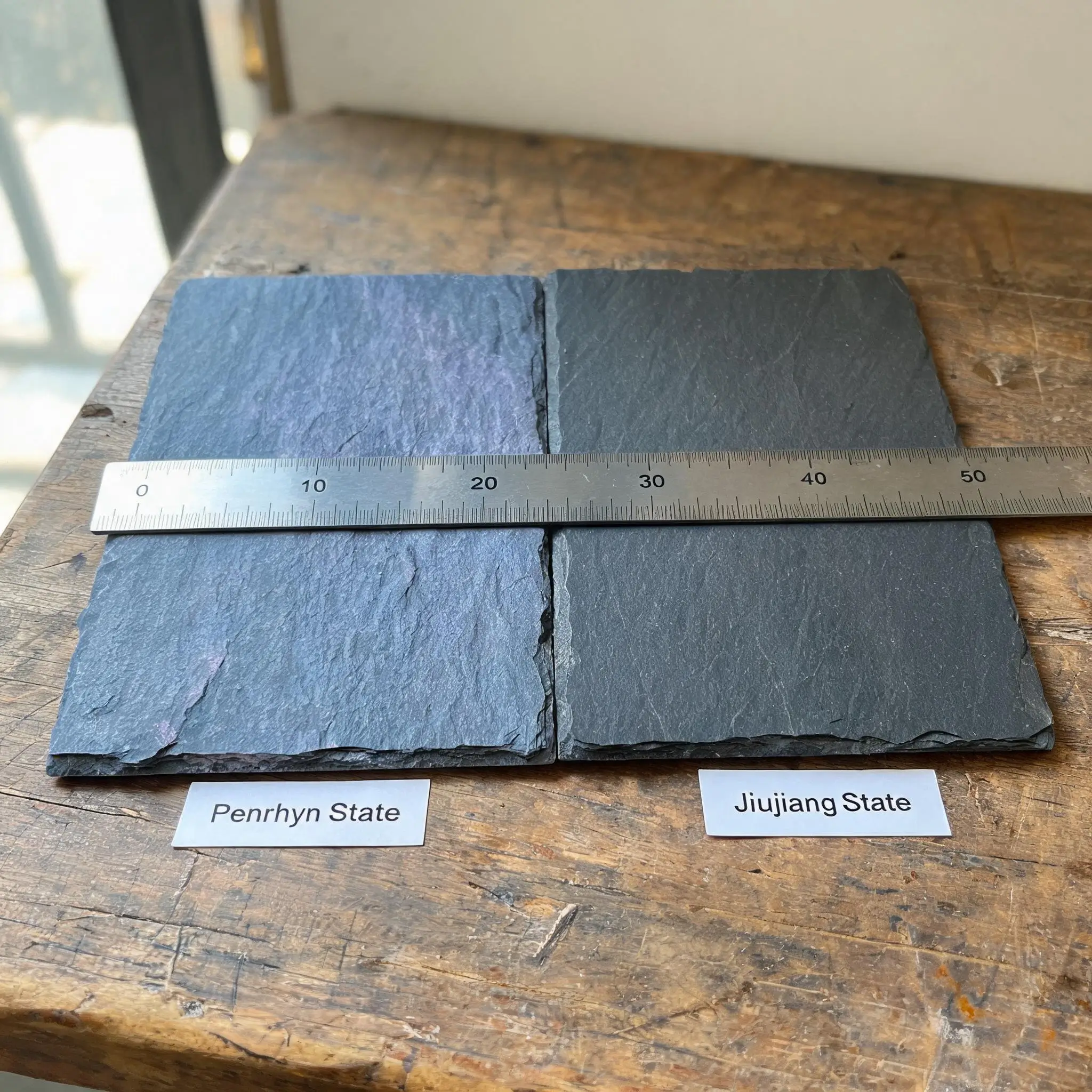 Interior of a Chinese slate processing factory with roofing tiles on inspection tables and measuring tools