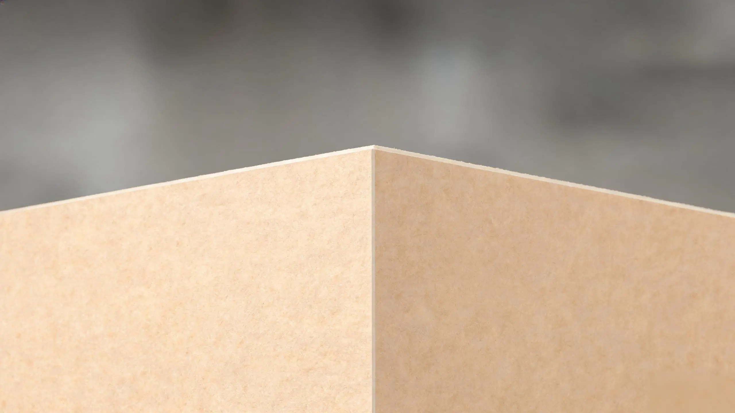 Close-up of the smooth, uniform surface and crisp factory edge of a new MDF board