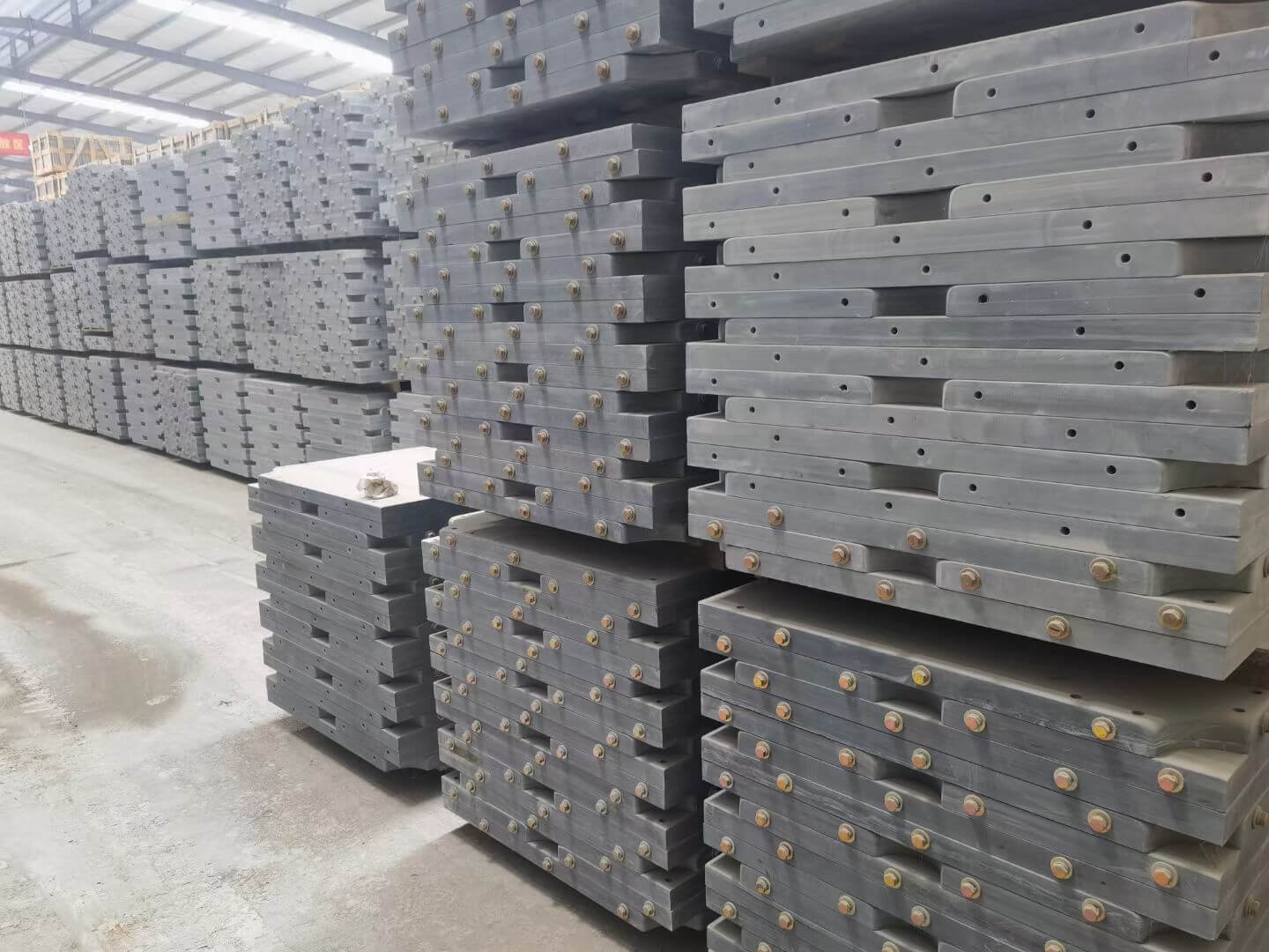 Billiard slate panels of different types stored in a production facility Hundreds of finished and unfinished billiard slate panels stacked in a factory warehouse, showing different types ready for shipment