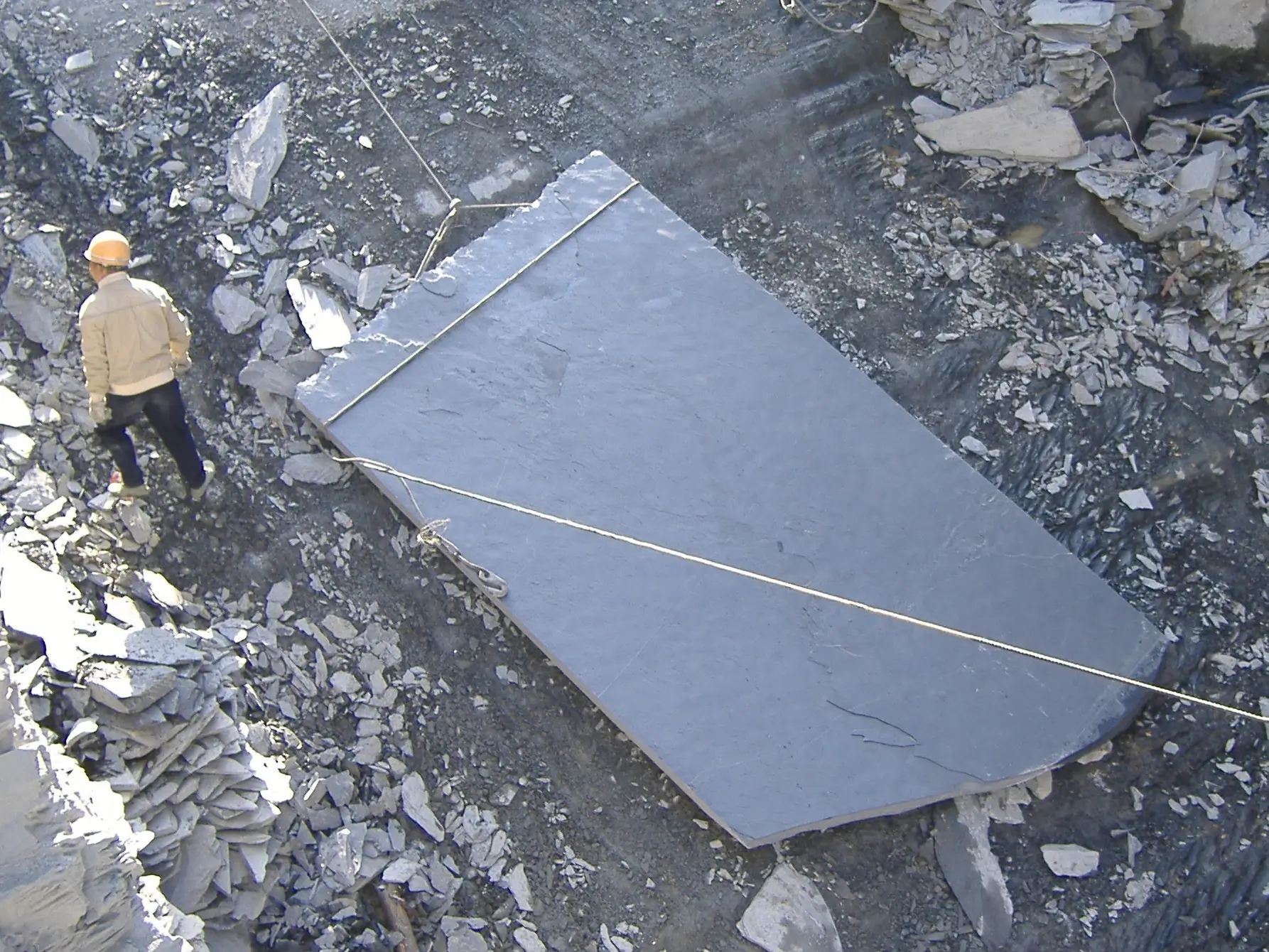 Slate blocks supported on timber at a quarry near Lushan, waiting for selection