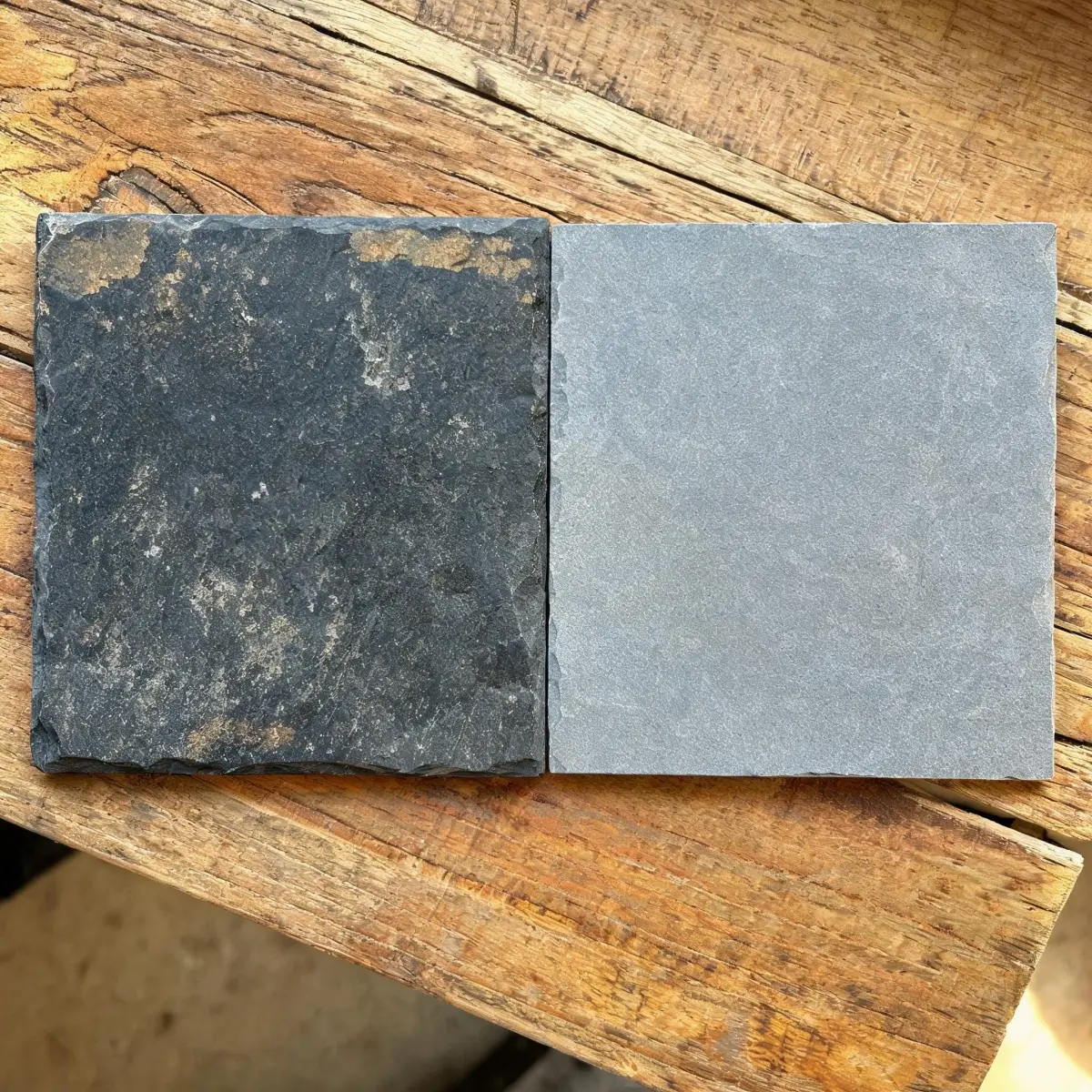 Can Roofing Slate Be Reused or Recycled? 4 Weathered reclaimed slate tile compared to a new slate tile side by side on a workbench