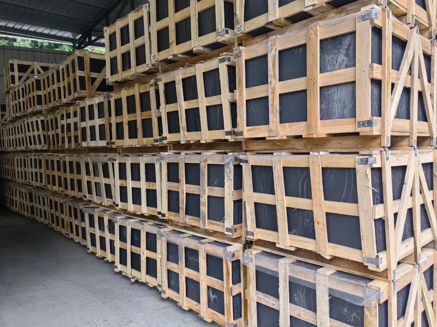 The Jiujiang Slate Industry 5 Wooden export crates packed with roofing slate tiles stacked in a factory yard