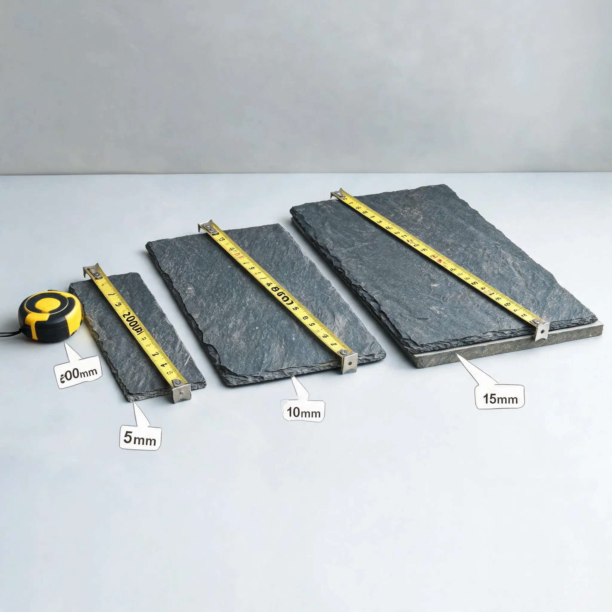 Roofing Slate FAQ 3 Roofing slate tiles in different sizes and thicknesses arranged for comparison