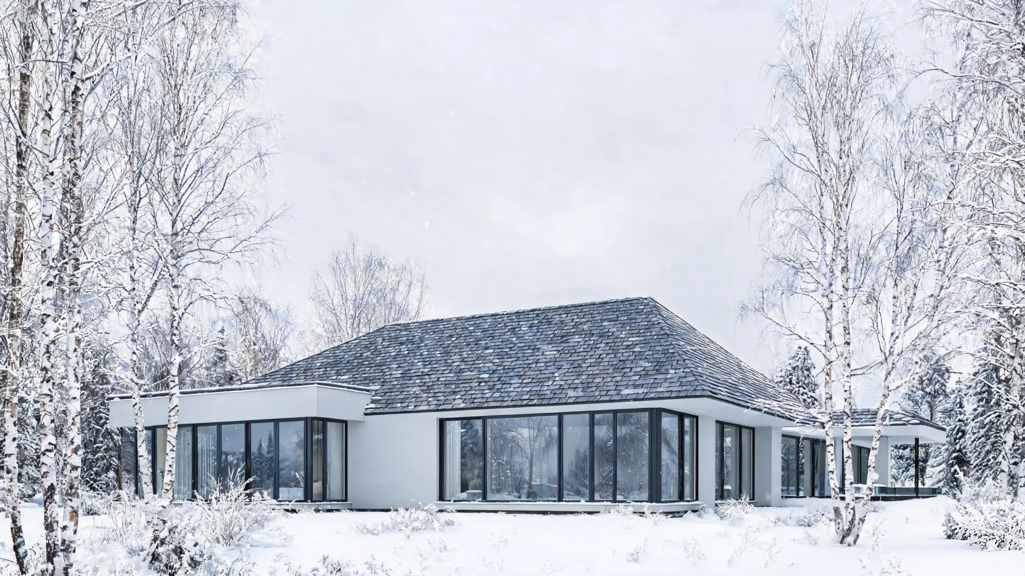 Scandinavian modern villa with dark grey slate roof in snow