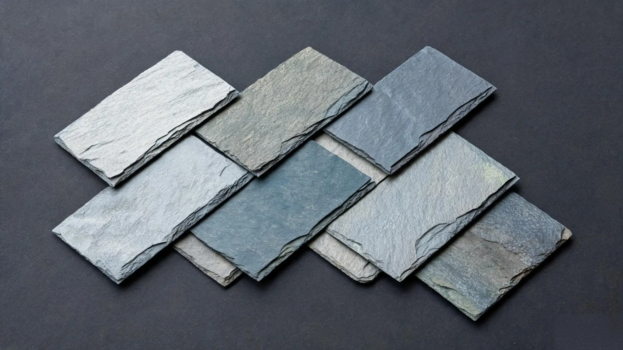 Close-up of the side of a grey slate block showing thin horizontal layering lines and natural cleavage planes