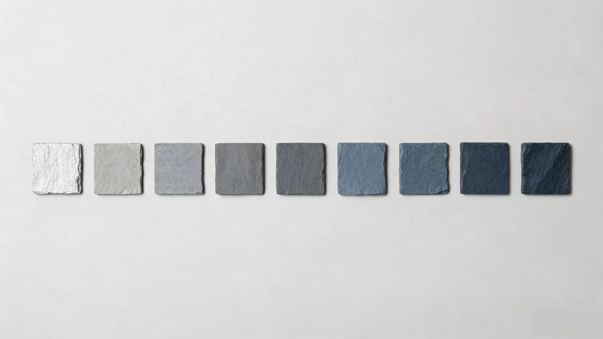 Row of slate colour chips from pale silver grey to deep blue-grey