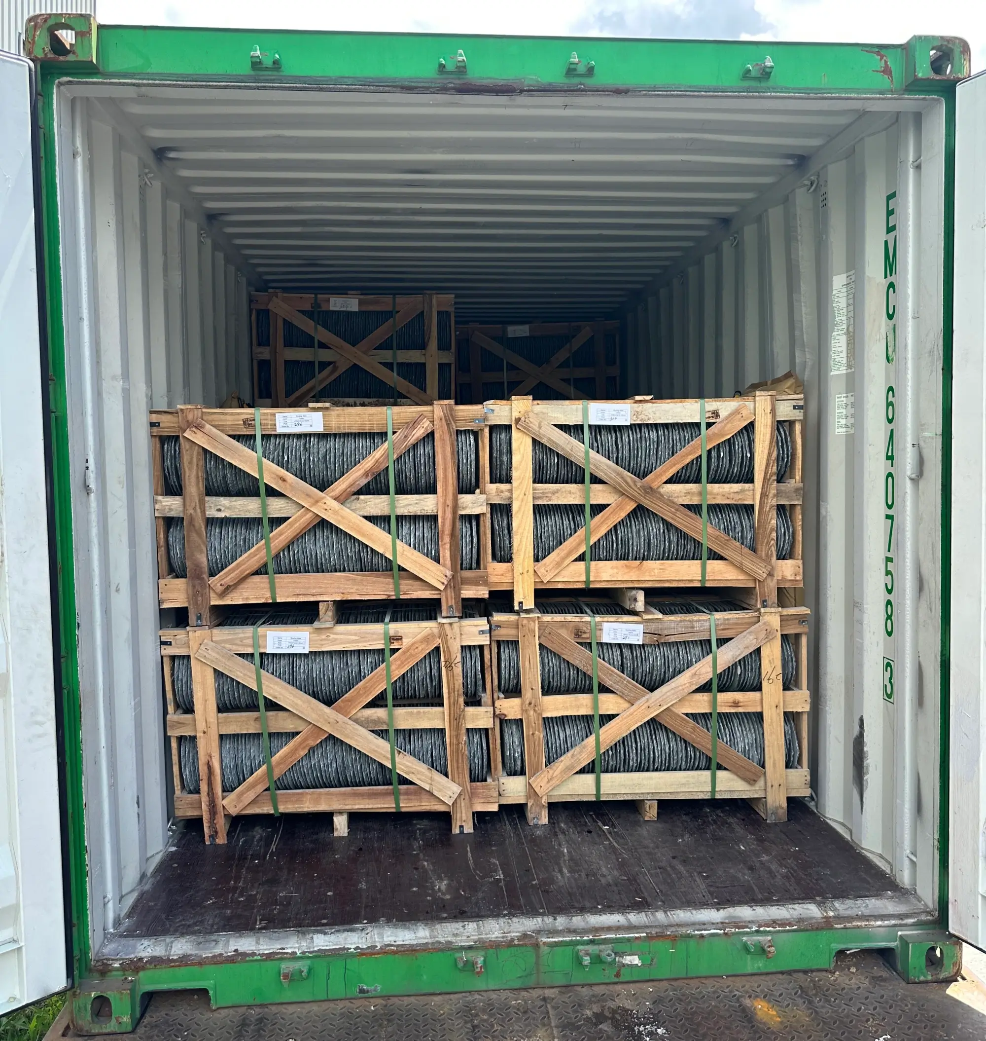 Container loading with wooden crates of slate Shipping container being loaded with wooden crates of natural slate at a factory yard