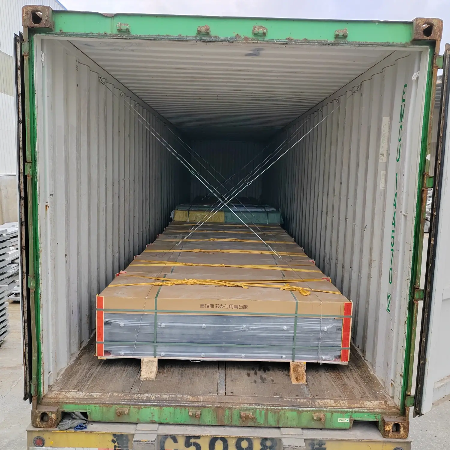Slate crate braced at the container door Final row of wooden slate crates inside the container doorway secured with timber blocking and wooden wedges