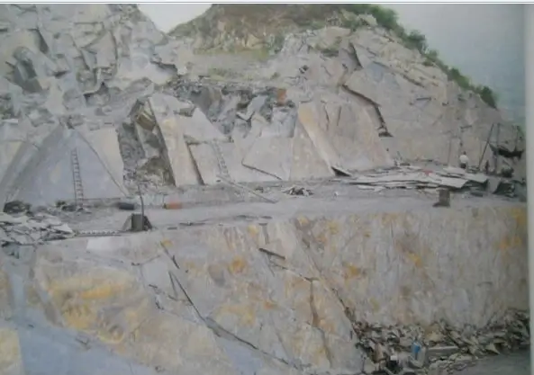 Slate quarry with benched working faces Hillside slate quarry with stepped bench-cut faces in the Jiujiang slate belt