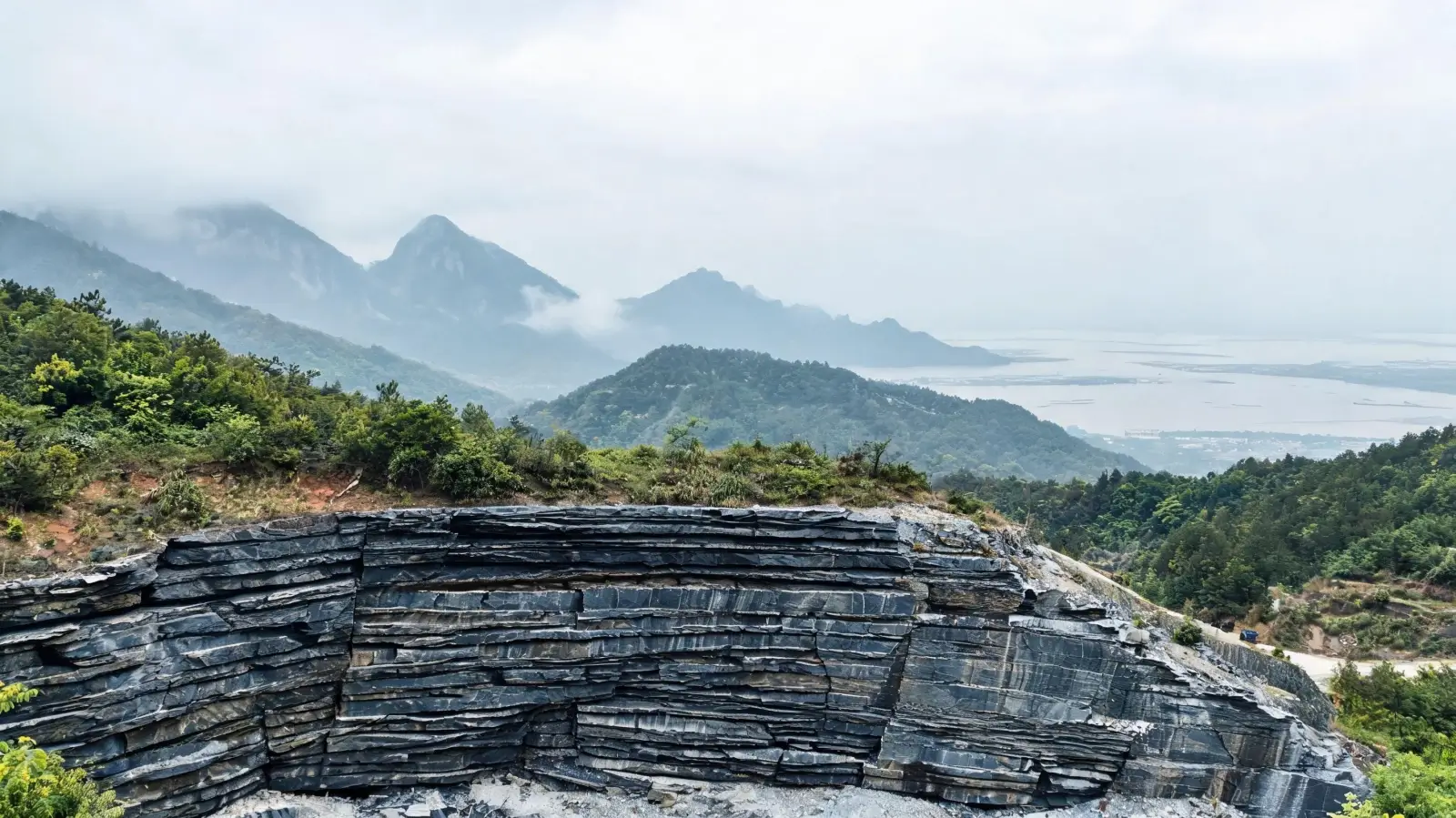 Slate quarry in the foothills of Lushan showing layered metamorphic slate rock formations