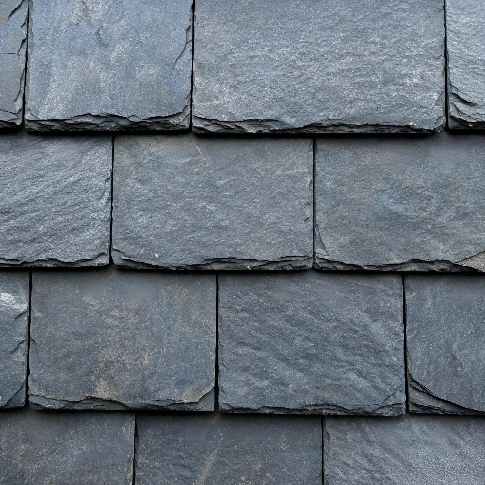 Jiujiang Roofing Slate in Cold and Coastal Climates 4 Close-up of slate roof tiles with copper nail fixings showing overlapping pattern for wind exposure