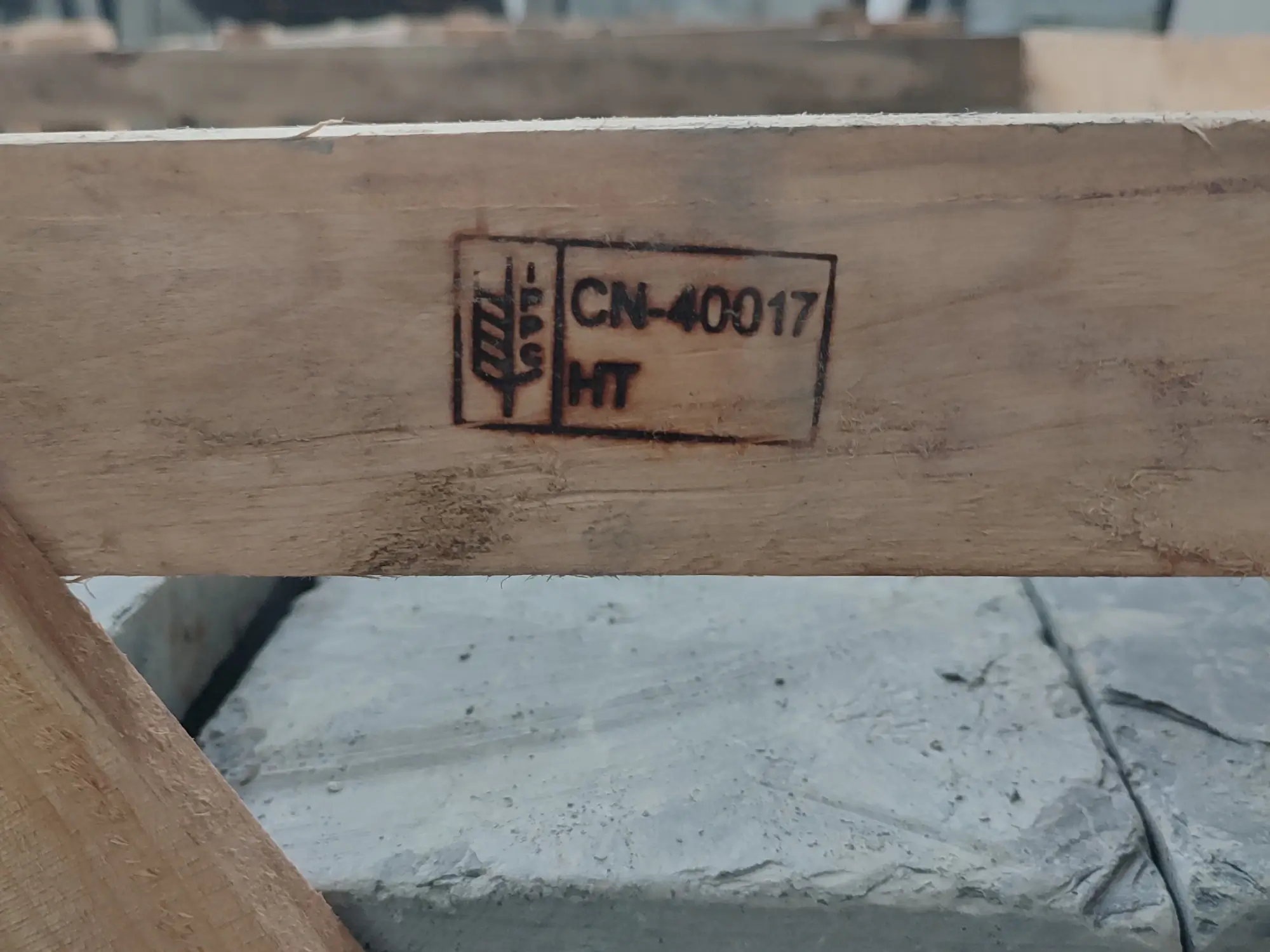 Close-up of stencil markings on a wooden shipping crate for slate