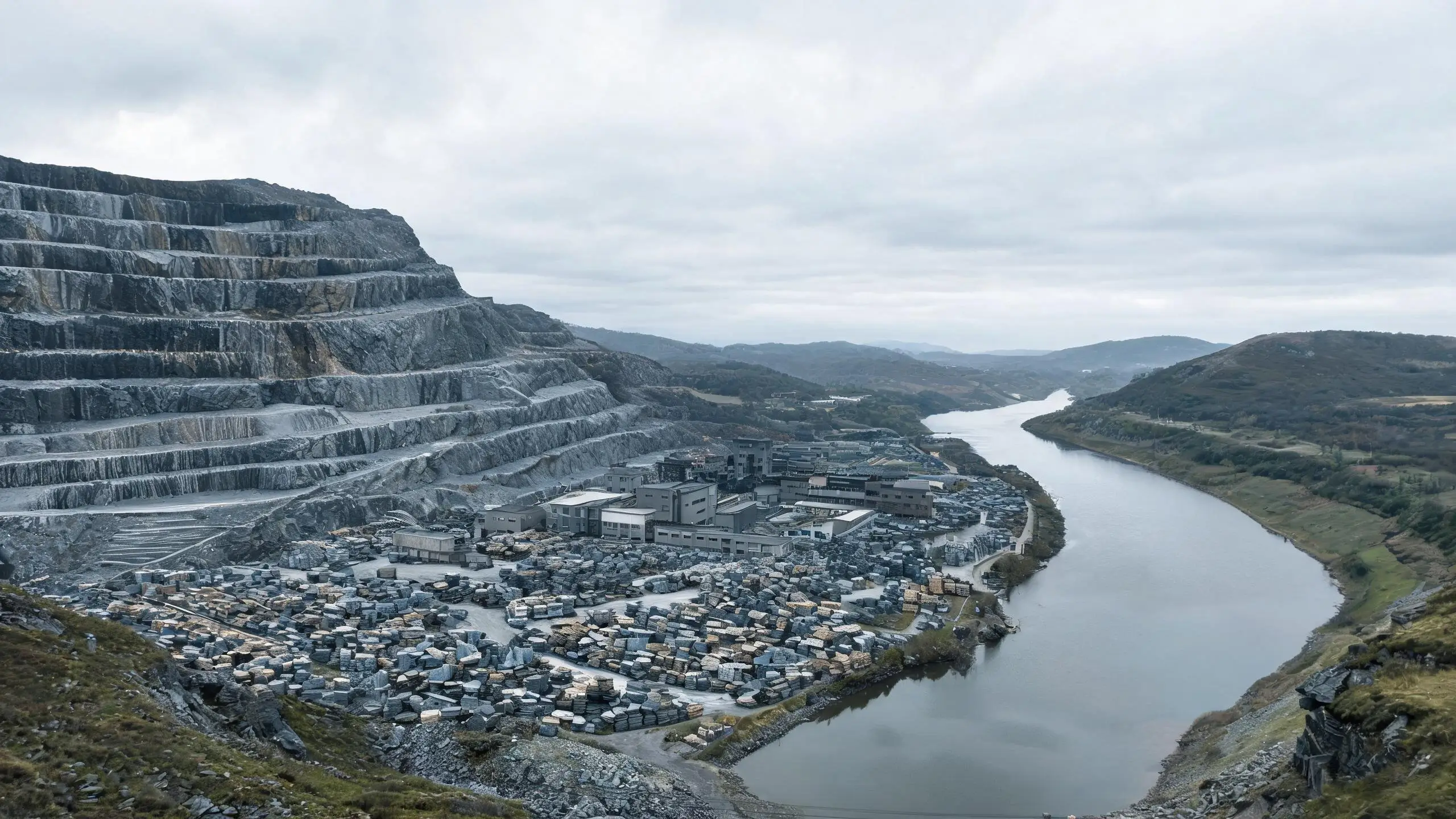 Aerial landscape of a Chinese slate-producing region with quarry, factory buildings and a river port