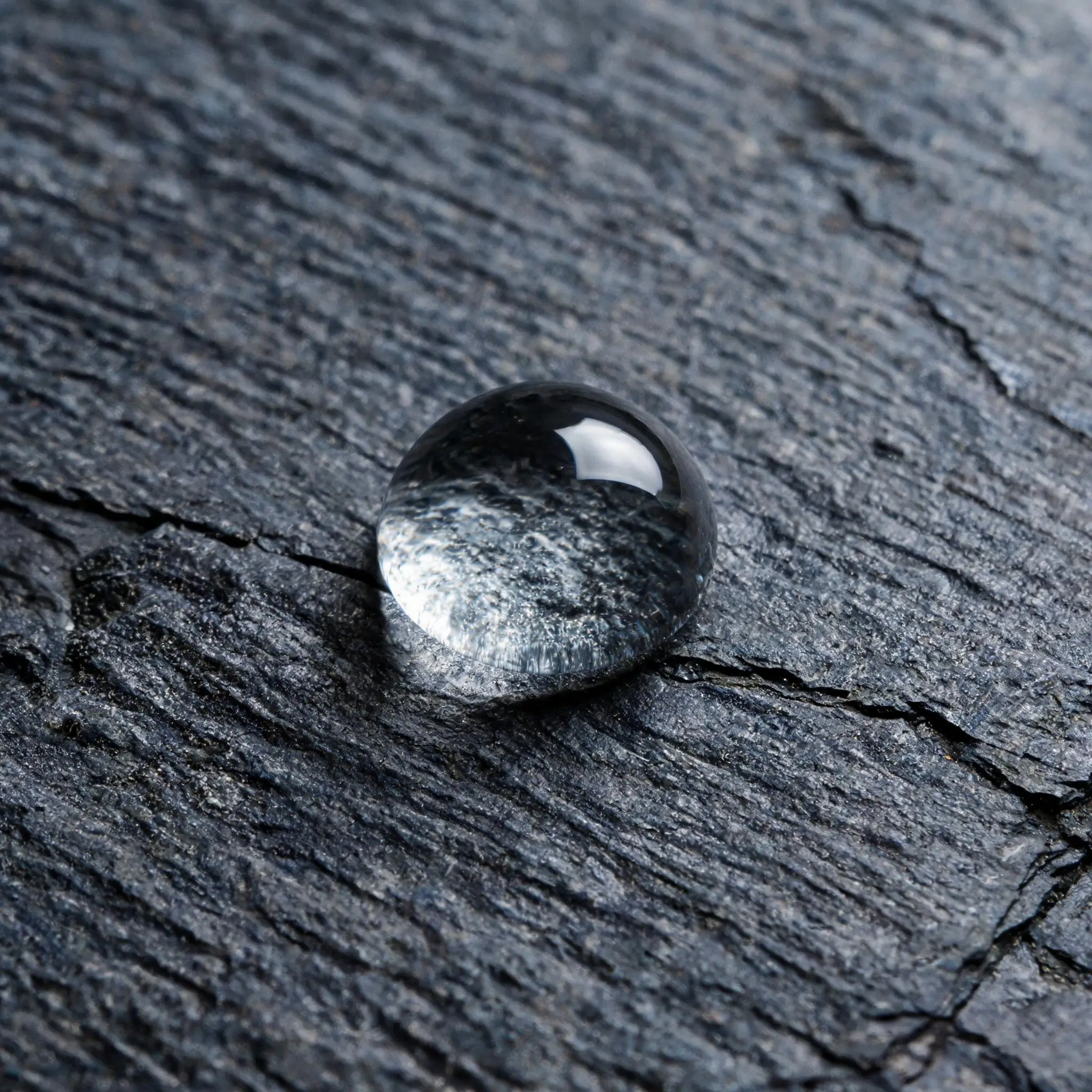Jiujiang Roofing Slate in Cold and Coastal Climates 3 Water droplet beading on the dense surface of natural grey slate showing low absorption