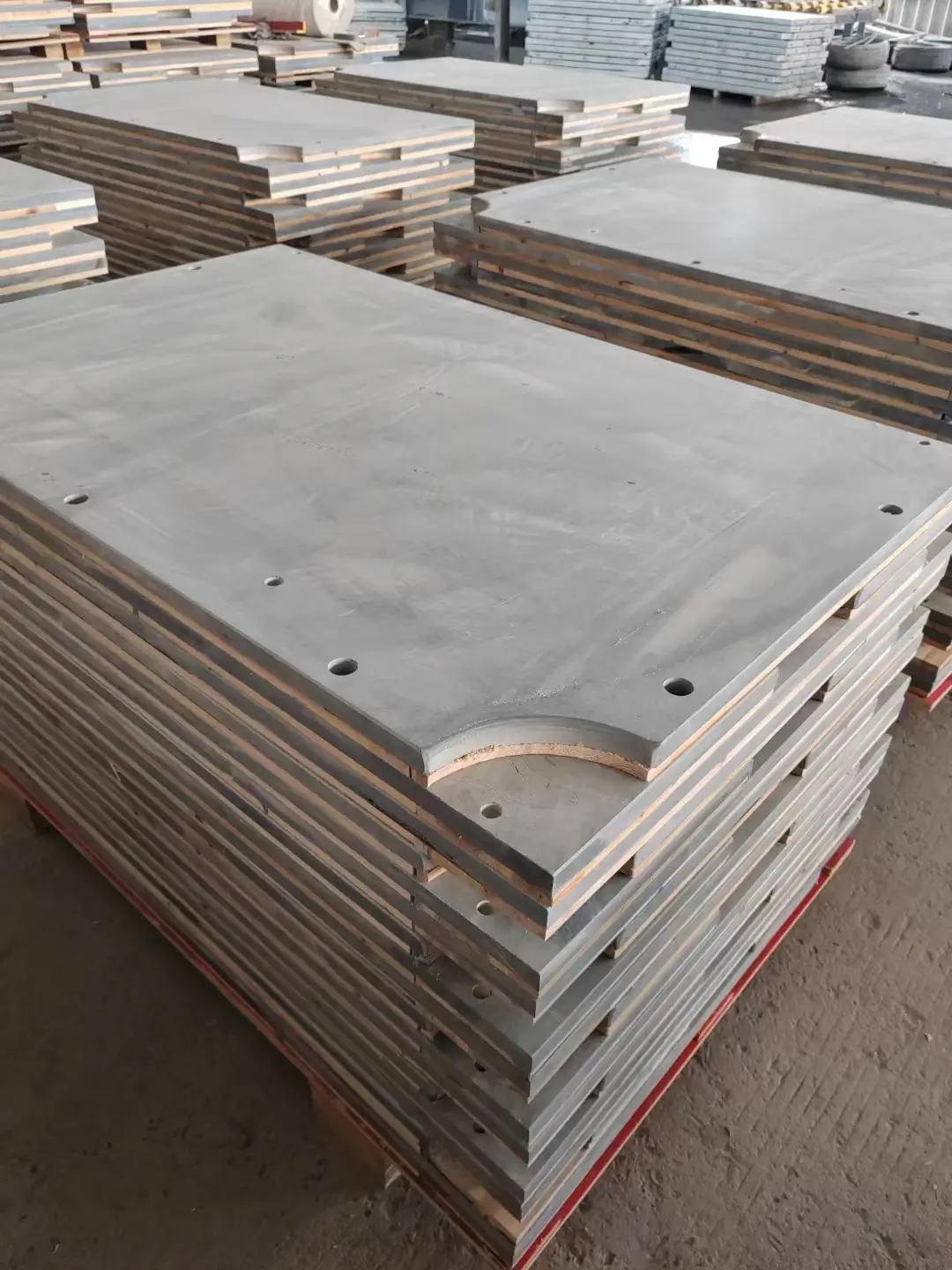 Three-piece slate sets stored flat in the warehouse Three-piece pool slate sets stacked flat on pallets with timber separators in a warehouse