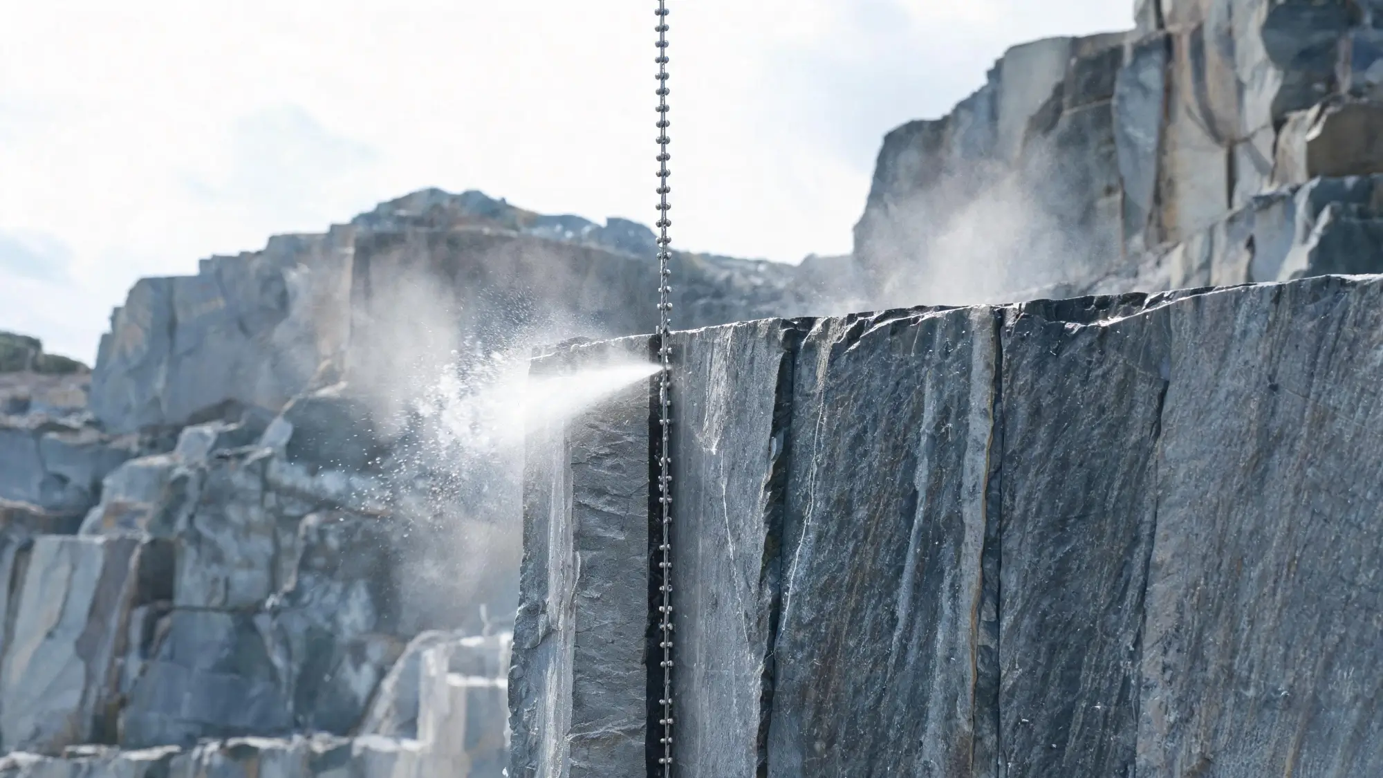 Wire saw cutting method for slate block extraction Diamond wire saw cutting a clean vertical face through grey slate in a quarry