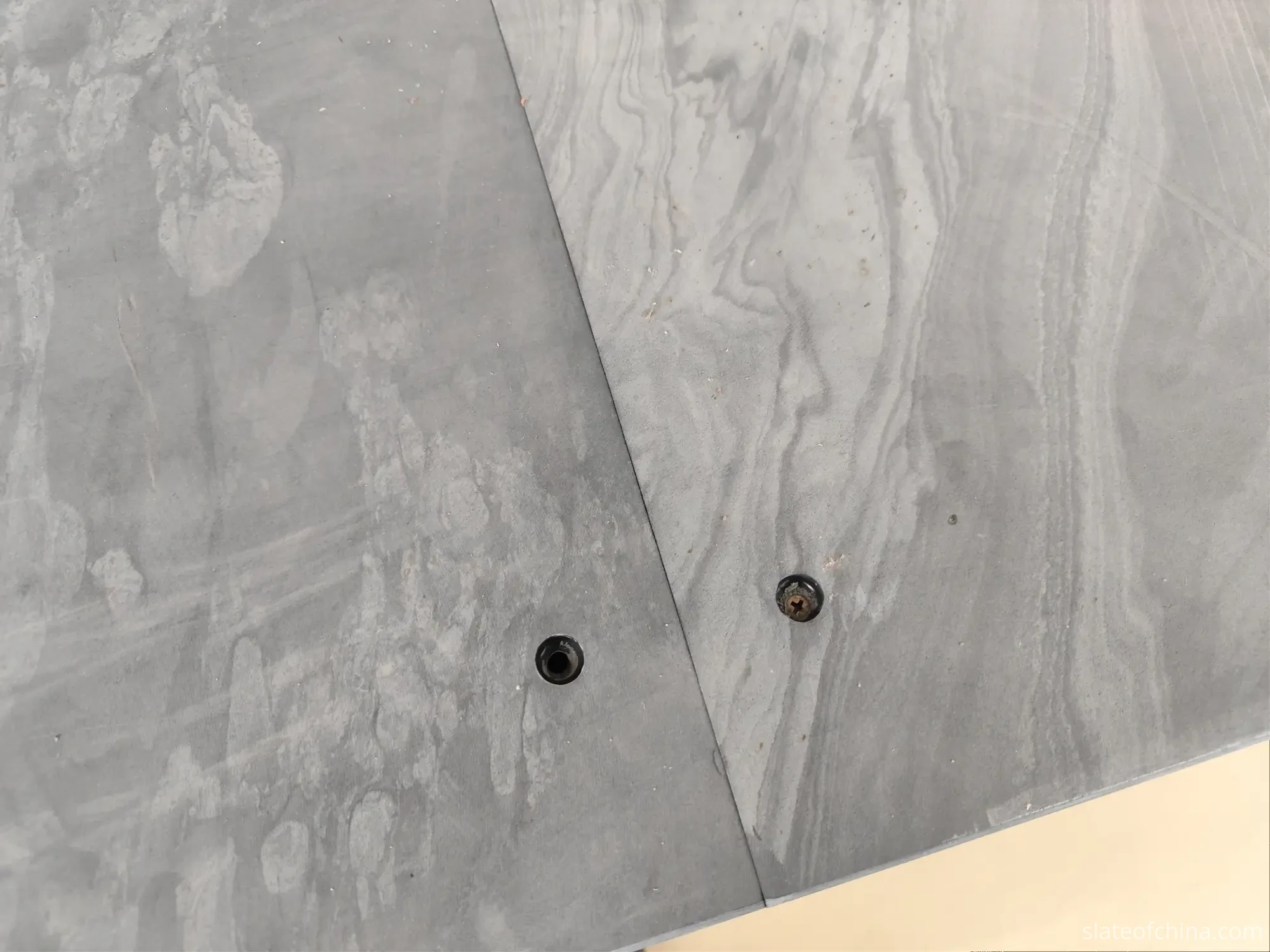 Surface Quality Inspection 5 Countersunk bolt holes machined beside a slate panel seam, one empty and one with its bolt seated flush