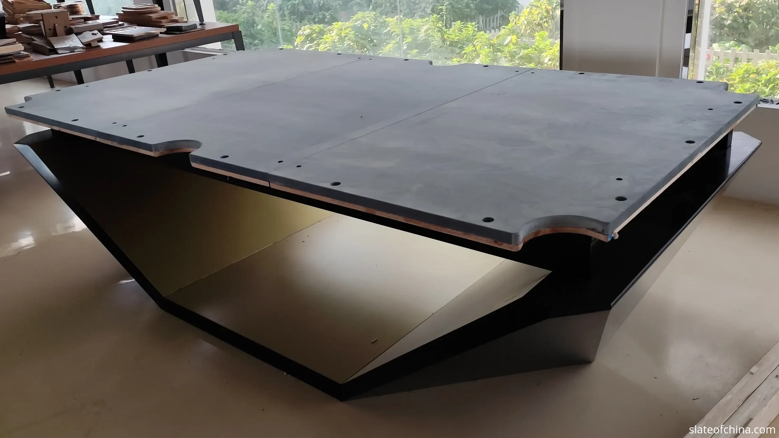 Billiard Slate FAQ 2 Three-piece billiard slate set assembled on a wooden table frame, three panels meeting flush in one plane with two straight joint lines across the bed