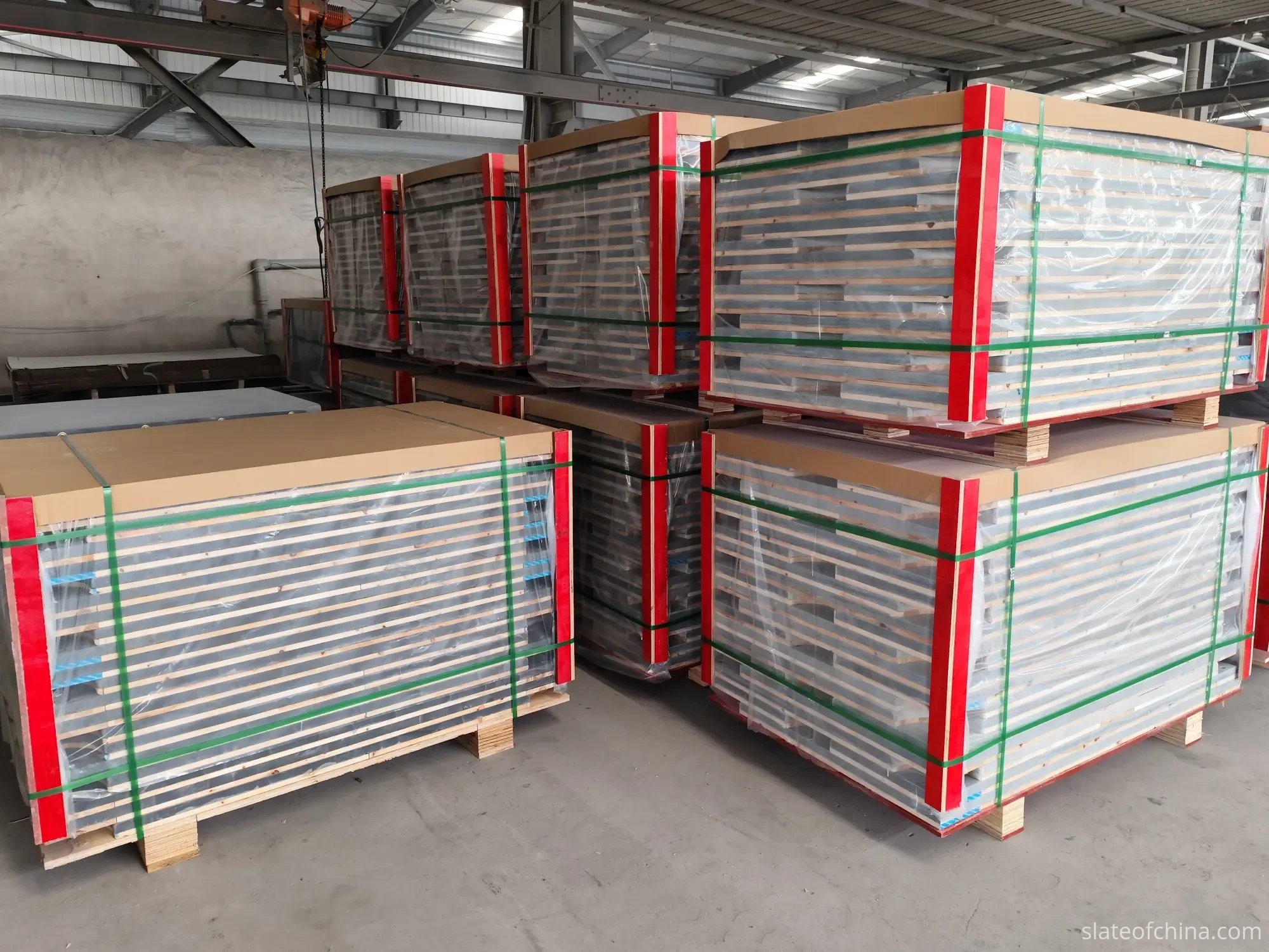 OEM Billiard Slate Manufacturing Process 6 Packed billiard slate pallets stacked in the factory warehouse under steel trusses and skylights, ready for container loading