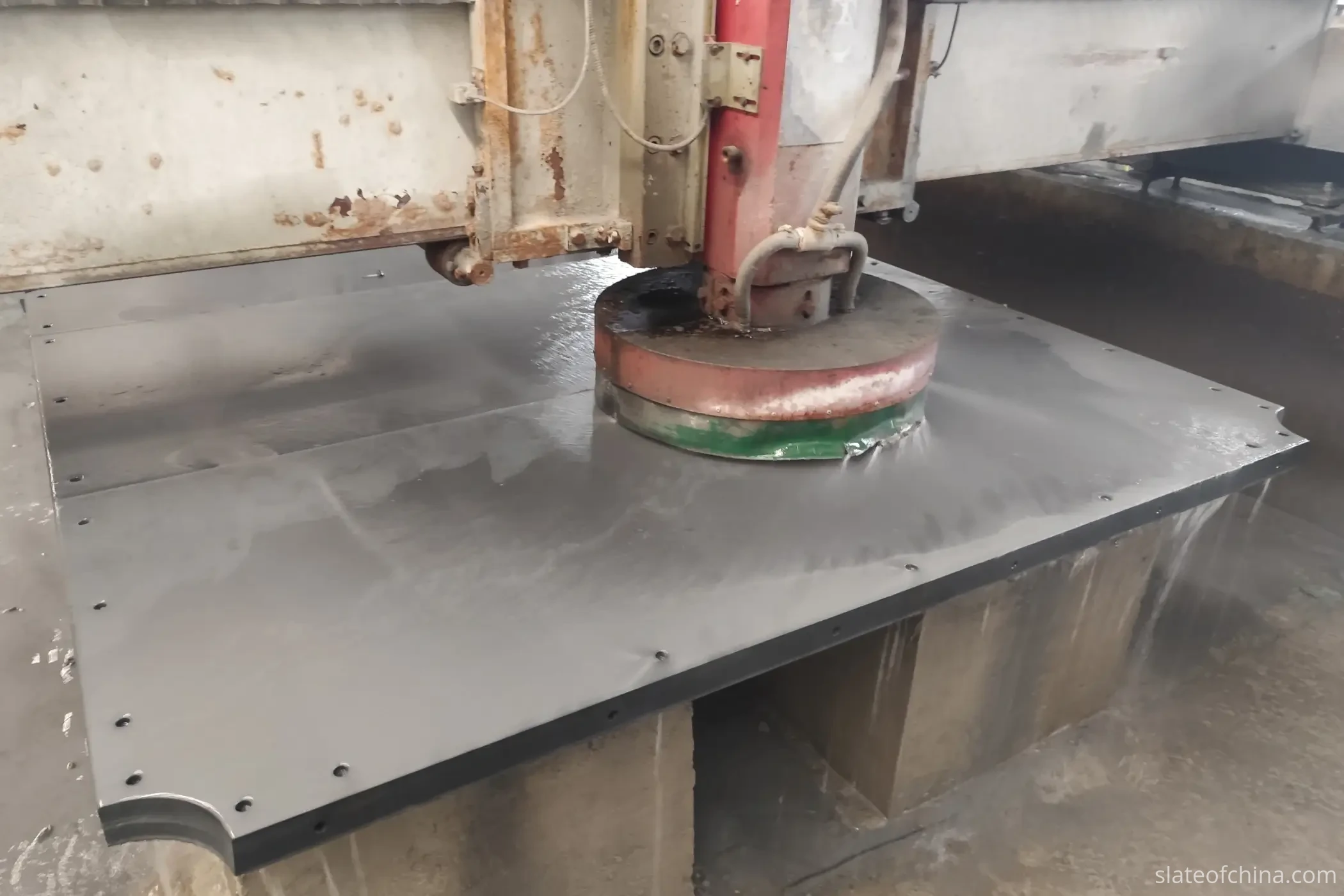 Cup wheel grinding a slate billiard surface Cup wheel wet grinding a slate billiard surface on a gantry machine