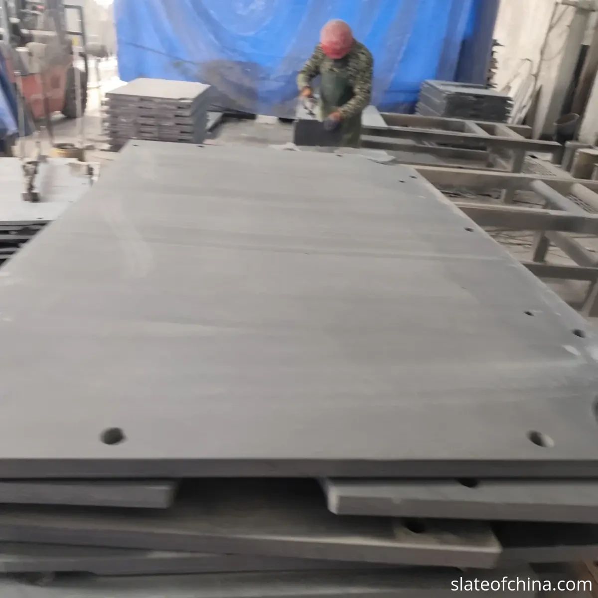 Custom Billiard Slate Manufacturing 1 Engineering review desk with technical drawings, CAD screen and dark grey billiard slate samples in a factory office