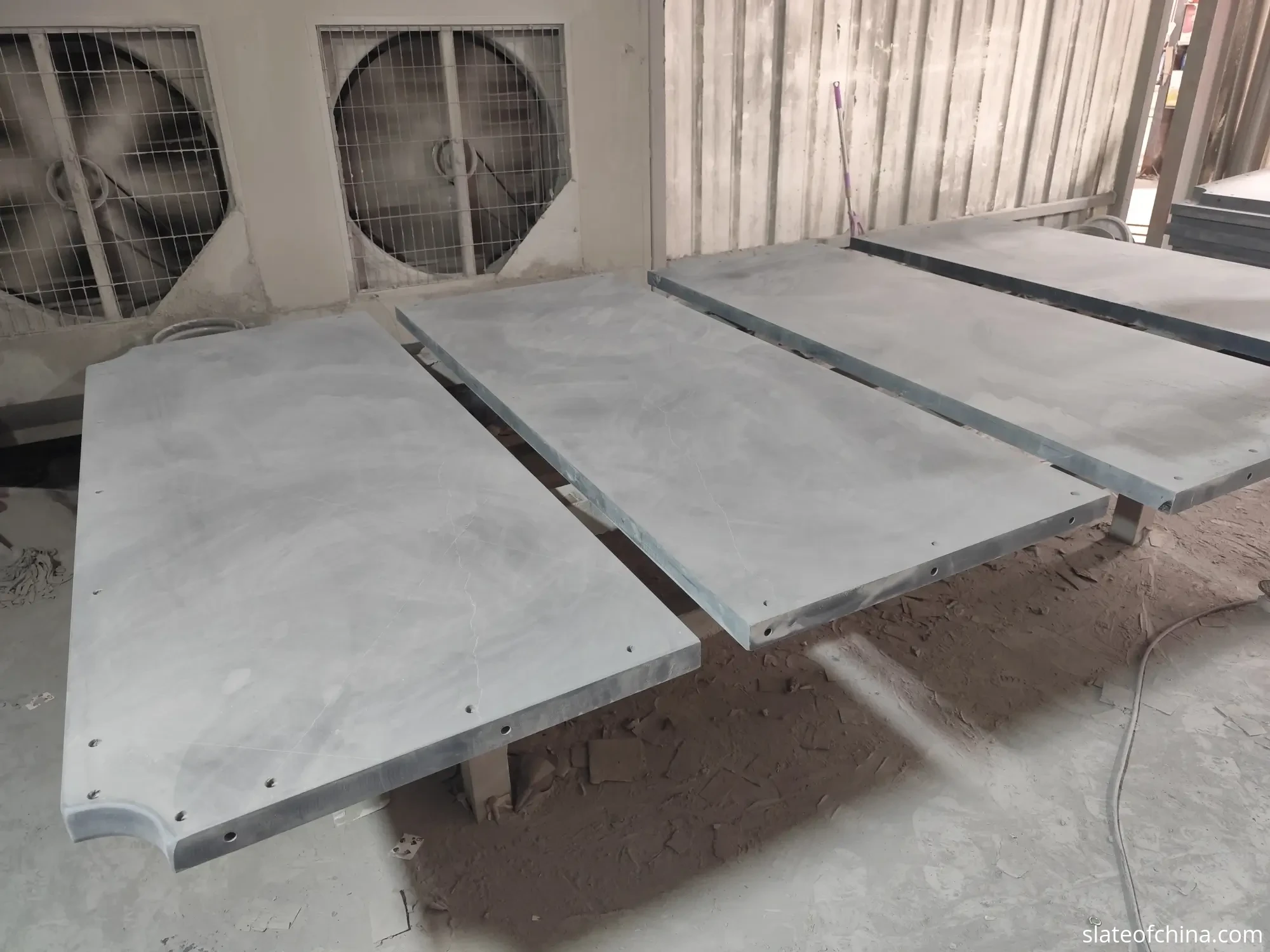 Custom Billiard Slate Manufacturing 5 Three billiard slate panels of different sizes arranged side by side on a factory floor