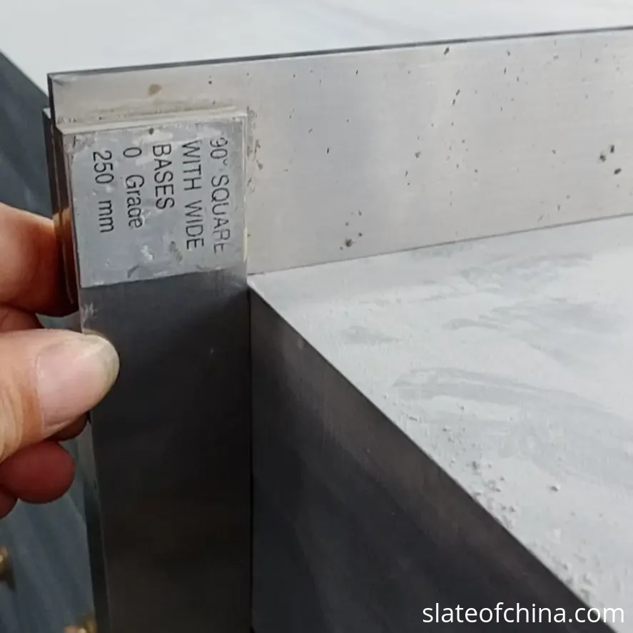 Custom Billiard Slate Manufacturing 6 Quality control inspector using a metal straightedge to check flatness of a billiard slate panel