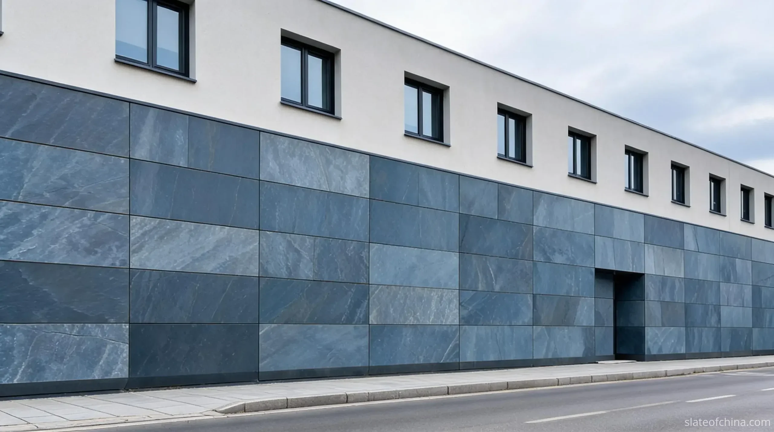 Exterior vs Interior Slate Cladding 4 Contemporary building with lower storeys clad in large rectangular blue-grey slate rainscreen panels with even joints