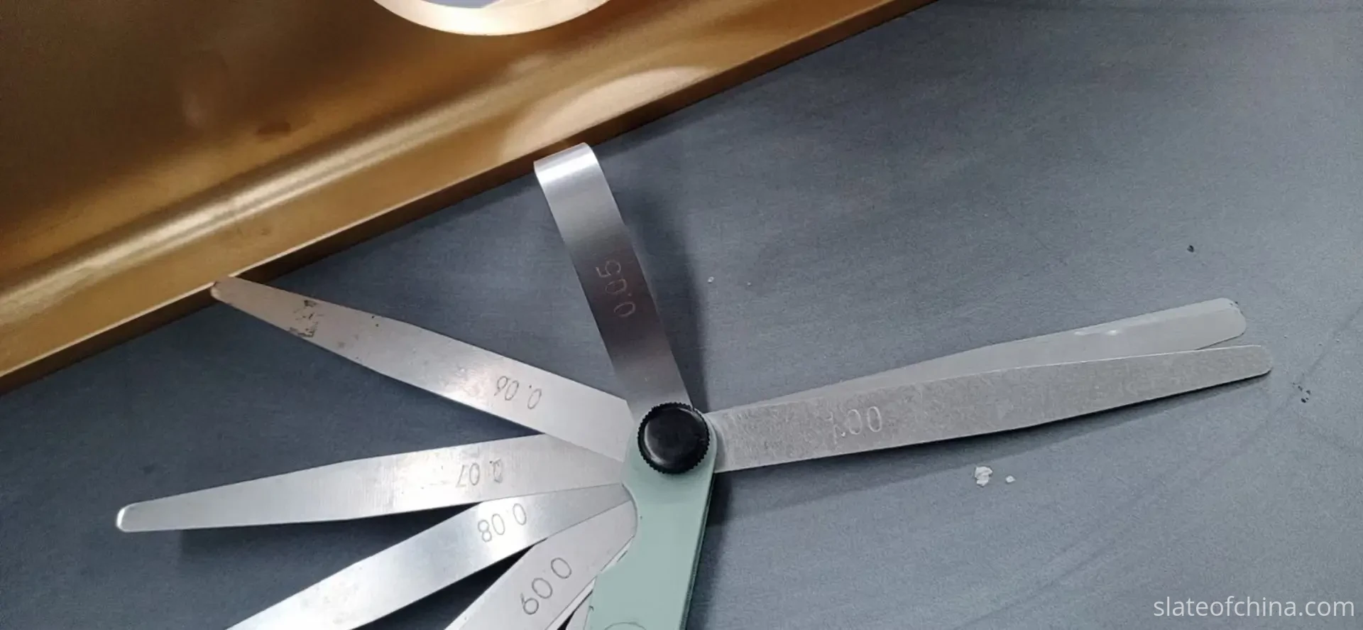 Feeler Gauge Blades on Slate Surface Feeler gauge blades laid flat on a honed billiard slate surface