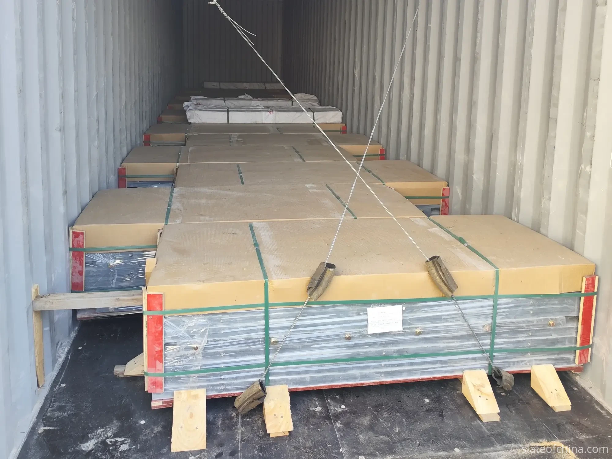 Jiujiang Slate Buyer Checklist 4 Wooden slate crates staged on the ground beside an open container at a factory loading bay